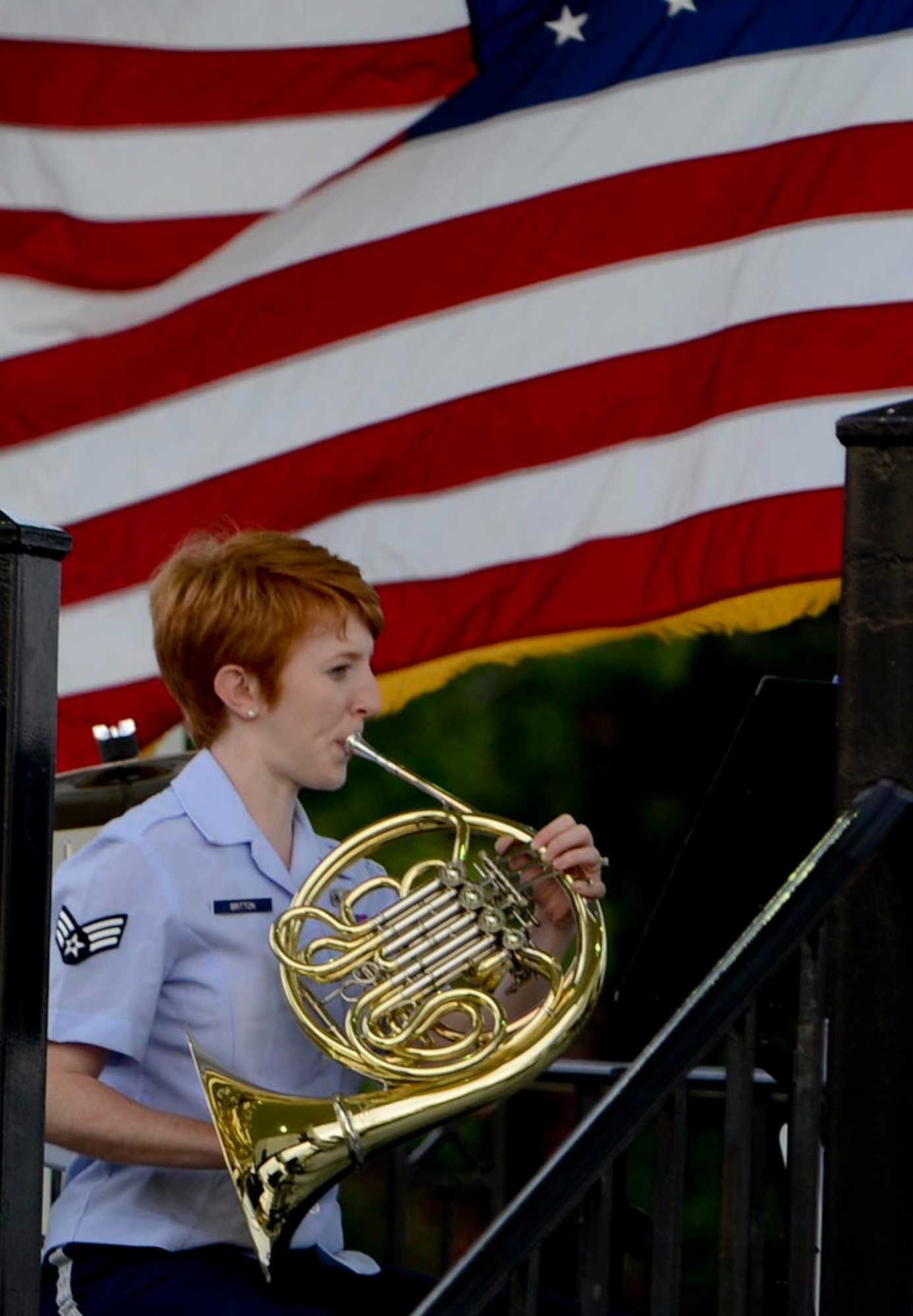 U.S. Air Force Senior Airman Emily Britton, U.S. Air Force Heritage of America Band member, plays the French horn during the Heritage Brass Quintet’s rendition of George Gershwin’s “Summertime,” during the Music by the Bay summer concert series at Continental Park at Fort Monroe, Va., Aug. 8, 2013. The Heritage Brass Quintet was formed in 1973 and tours the mid-Atlantic region from South Carolina to Delaware, playing all genres of music ranging from classical to jazz and popular music. (U.S. Air Force photo by Airman 1st Class R. Alex Durbin/Released)