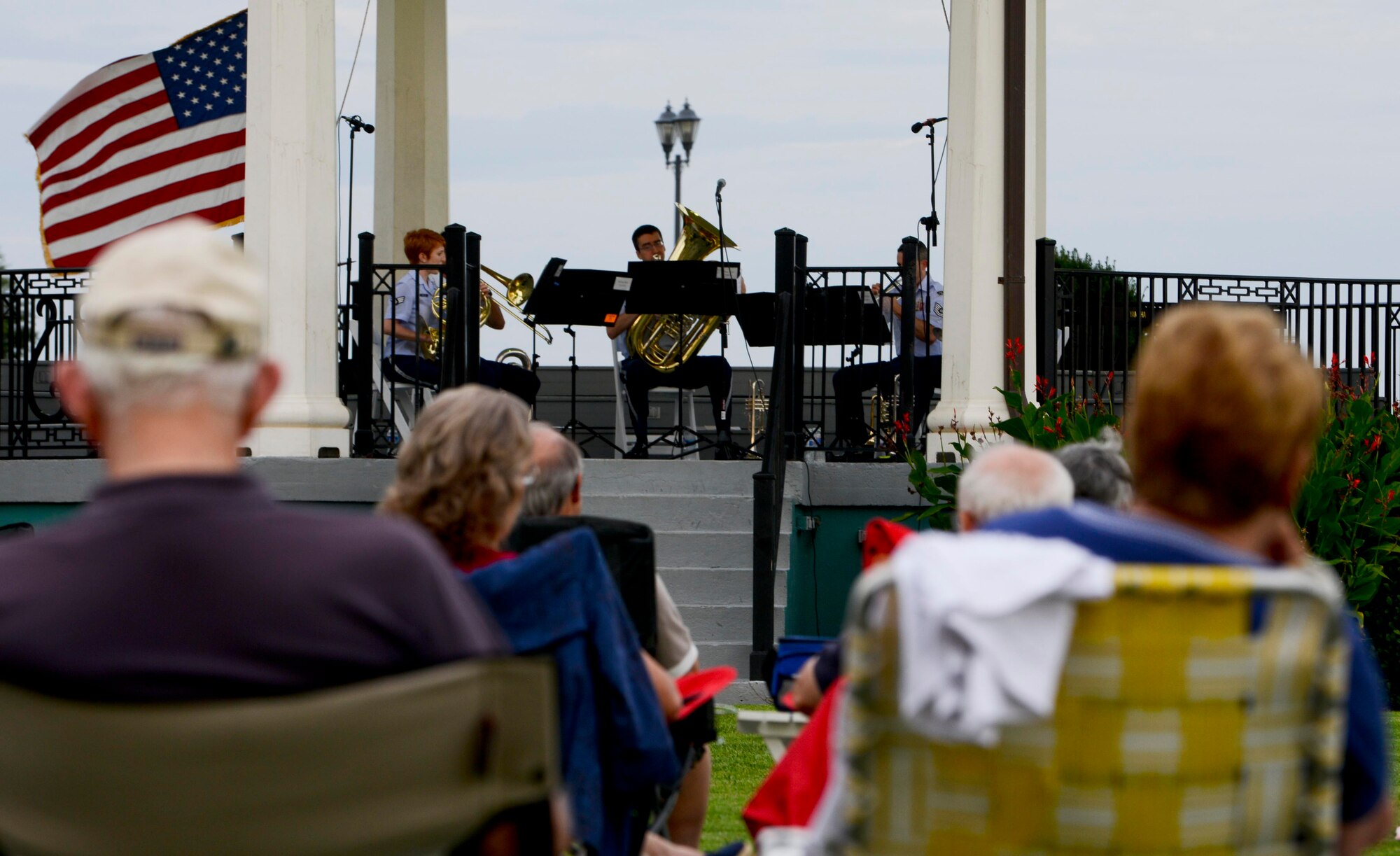 Spectators listen as the U.S. Air Force Heritage of America Band Heritage Bass Quintet performs a medley of patriotic songs at Continental Park at Fort Monroe, Va., Aug. 8, 2013. The Music by the Bay summer concert series is free and features local regional military bands, culminating in a performance by the Virginia Symphony Orchestra, Aug. 30, 2013. (U.S. Air Force photo by Airman 1st Class R. Alex Durbin/Released)