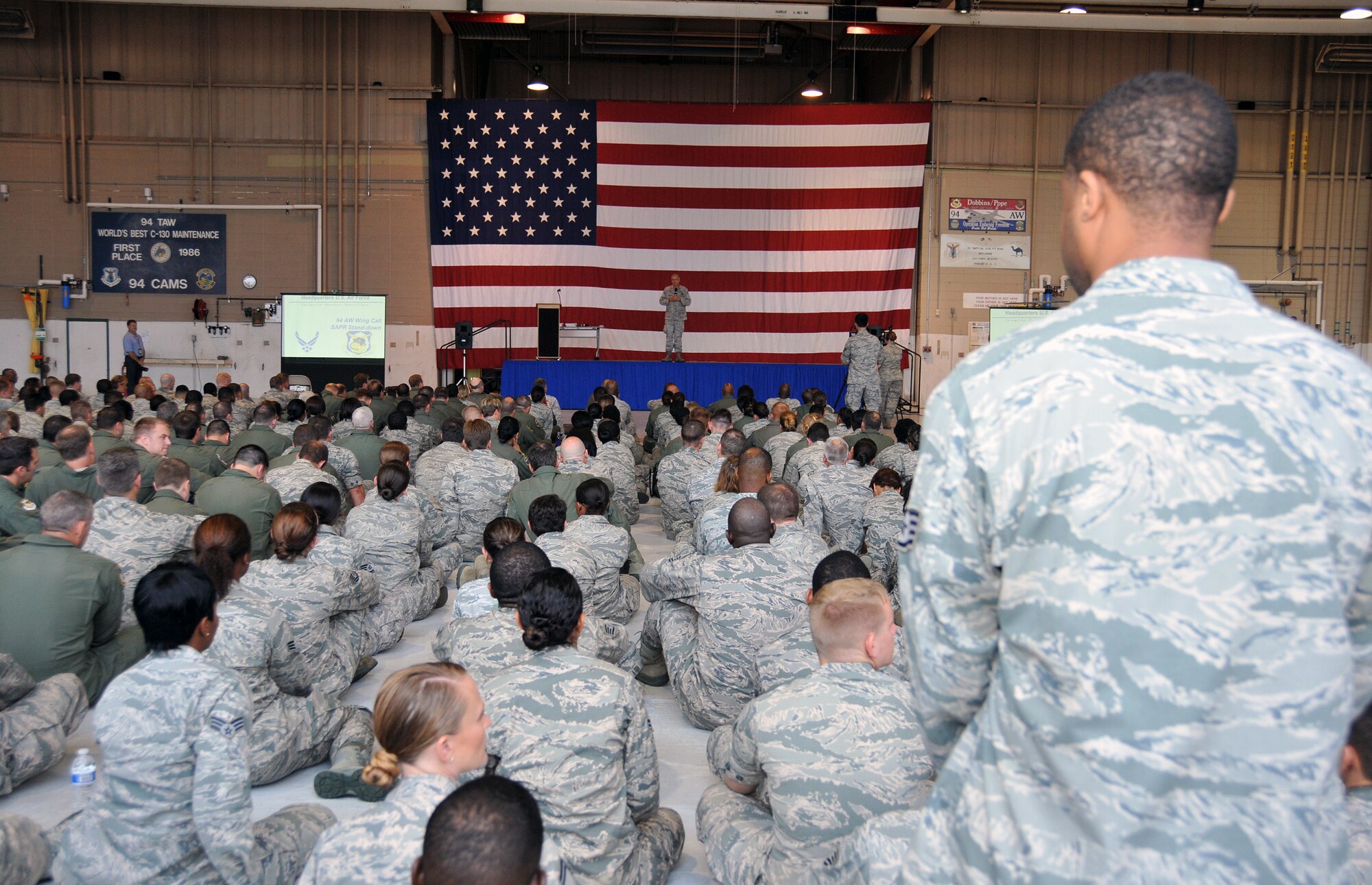 Col. Tim Tarchick, 94th Airlift Wing commander, addresses members of the wing regarding sexual assault awareness on Aug. 4 on base. The wing-wide commander's call was part of a SAPR stand-down following direction from the secretary of defense to conduct training for personnel before Aug. 31. (U.S. Air Force photo/Senior Airman Elizabeth Van Patten)