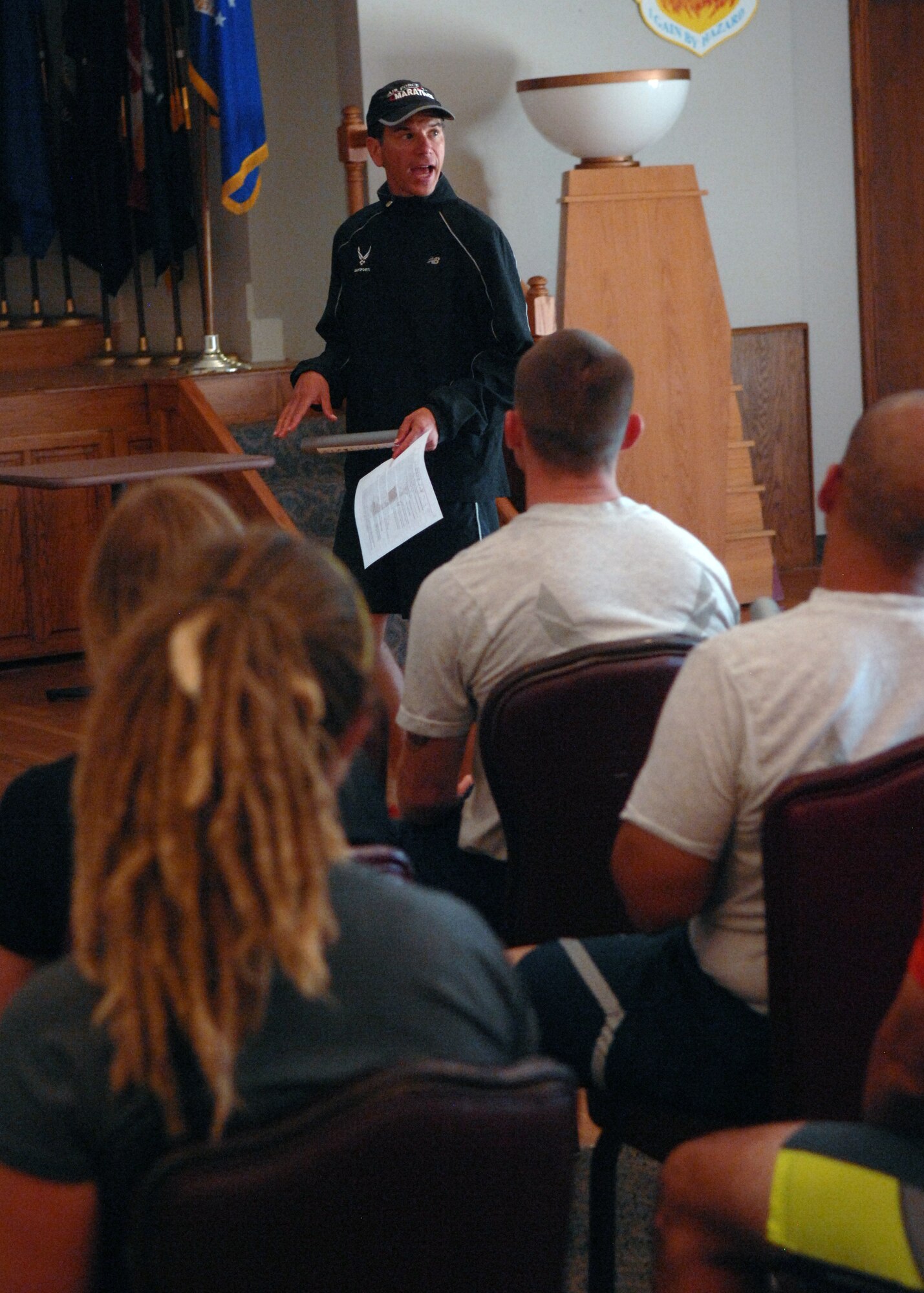 U.S. Air Force Lt. Col. Antonio Eppolito, Air Force Medical Support Agency, speaks to Airmen about efficient running during a seminar Aug. 7, 2013, at the Dyess Event Center on Dyess Air Force Base, Texas. During the seminar, Eppolito provided the members with information on aerobic development, running form, injury prevention and how to improve performance. He educated servicemembers on the barefoot style running, which is more efficient for the body by limiting pain and injuries. This can be accomplished by wearing a minimalist running shoe. According to Eppolito, wearing thick-heeled tennis shoes force people to land on their heels, which causes more injuries and shortens the achilles tendon by limiting flexibility in the foot. Eppolito has been a member of the Air Force running team for 18 years and is a five-time Air Force Masters Half-Marathon champion. (U.S. Air Force photo by Senior Airman Shannon Hall/Released)