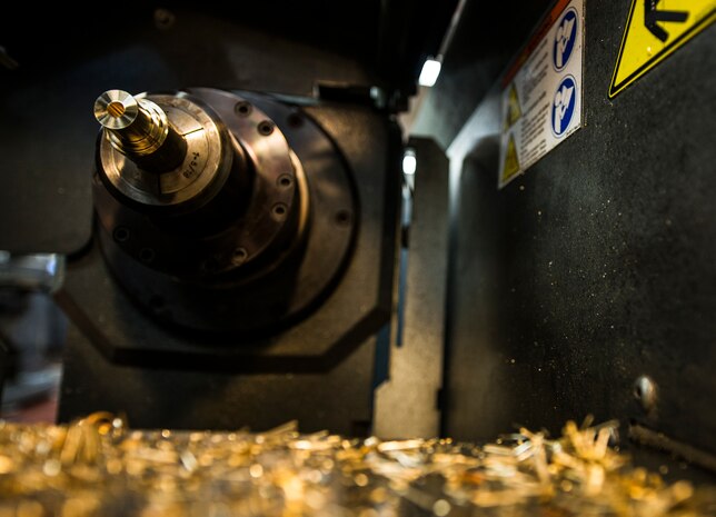 Sheet metal scraps are scattered around a lathe machine after a piece of aluminum is milled down to size Aug. 7, 2013, at Joint Base Charleston, S.C. Airmen from the aircraft metals fabrication shop are trained to use several different pieces of equipment to bend, cut and combine metals. (U.S. Air Force photo/Senior Airman Dennis Sloan)