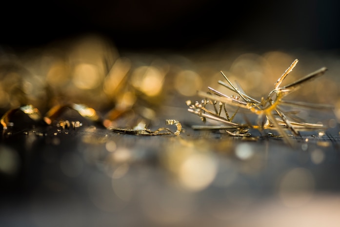 Sheet metal scraps are scattered around a lathe machine after a piece of aluminum is milled down to size Aug. 7, 2013, at Joint Base Charleston, S.C. Airmen from the aircraft metals fabrication shop are trained to use several different pieces of equipment to bend, cut and combine metals. (U.S. Air Force photo/Senior Airman Dennis Sloan)