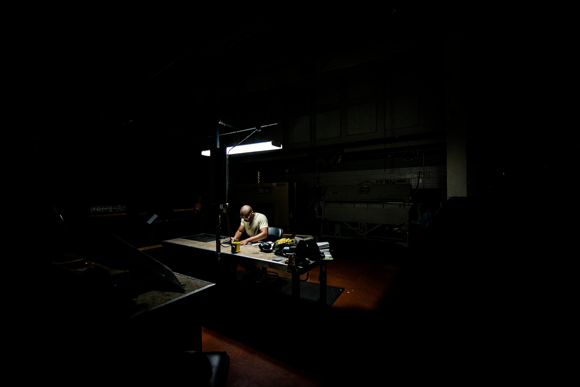 Airman 1st Class William Williams, 437th Maintenance Squadron aircraft metals technology journeyman, prepares to lay out a cut with a ruler and black marker on a sheet of metal Aug. 7, 2013, at Joint Base Charleston, S.C. The sheet metal is used to simulate steel work on a C-17 Globemaster III wing. (U.S. Air Force photo/Airman 1st Class Dennis Sloan)