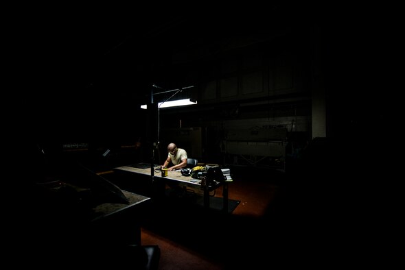 Airman 1st Class William Williams, 437th Maintenance Squadron aircraft metals technology journeyman, prepares to lay out a cut with a ruler and black marker on a sheet of metal Aug. 7, 2013, at Joint Base Charleston, S.C. The sheet metal is used to simulate steel work on a C-17 Globemaster III wing. (U.S. Air Force photo/Senior Airman Dennis Sloan) 

