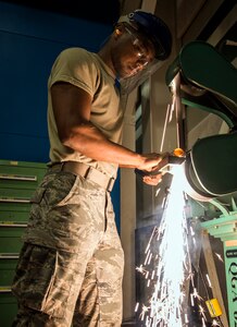 Airman 1st Class William Williams, 437th Maintenance Squadron aircraft metals technology journeyman, grinds a piece of steel tube Aug. 7, 2013, at Joint Base Charleston, S.C. The sheet metal is used to simulate steel work on a C-17 Globemaster III wing. (U.S. Air Force photo/Airman 1st Class Dennis Sloan)
