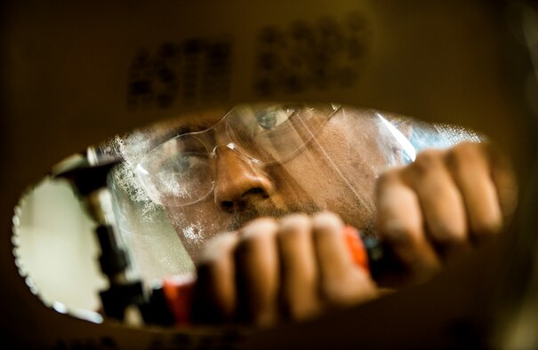Airman 1st Class William Williams, 437th Maintenance Squadron aircraft metals technology journeyman, uses a sander on the edges of a piece of sheet metal during training Aug. 7, 2013, at Joint Base Charleston, S.C. The sheet metal is used to simulate steel work on a C-17 Globemaster III wing. (U.S. Air Force photo/Senior Airman Dennis Sloan) 

