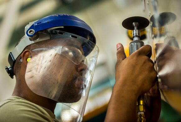 Airman 1st Class William Williams, 437th Maintenance Squadron aircraft metals technology journeyman, uses a saw to cut a hole out of a piece of sheet metal during training Aug. 7, 2013, at Joint Base Charleston, S.C. The sheet metal is used to simulate steel work on a C-17 Globemaster III wing. (U.S. Air Force photo/Senior Airman Dennis Sloan) 


