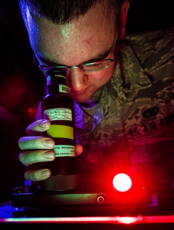 Senior Airman Nicholas Macdonald, 20th Component Maintenance Squadron Precision Measurement Equipment Laboratory Calibration technician from Shaw Air Force Base, S.C., performs a night vision goggle inspection Aug. 8, 2013, at the 437th Maintenance Group PMEL shop at Joint Base Charleston – Air Base, S.C. The airmen from Shaw AFB conducted the training here because their night vision inspection equipment was undergoing maintenance. The airmen confirmed that the optics in the night vision equipment work properly. (U.S. Air Force photo/ Senior Airman Dennis Sloan)