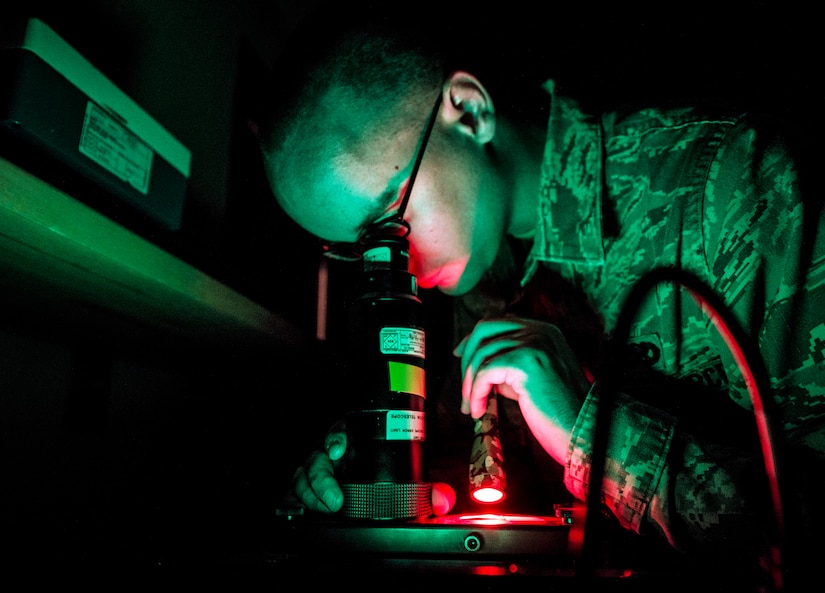 Senior Airman Kelsey Blair, 20th Component Maintenance Squadron Precision Measurement Equipment Laboratory Calibration technician from Shaw Air Force Base, S.C., performs a night vision goggle inspection Aug. 8, 2013, at the 437th Maintenance Group PMEL shop, Joint Base Charleston – Air Base, S.C. The airmen from Shaw AFB conducted the training here because their night vision inspection equipment was undergoing maintenance. The airmen confirmed that the optics in the night vision equipment work properly. (U.S. Air Force photo/ Senior Airman Dennis Sloan)
