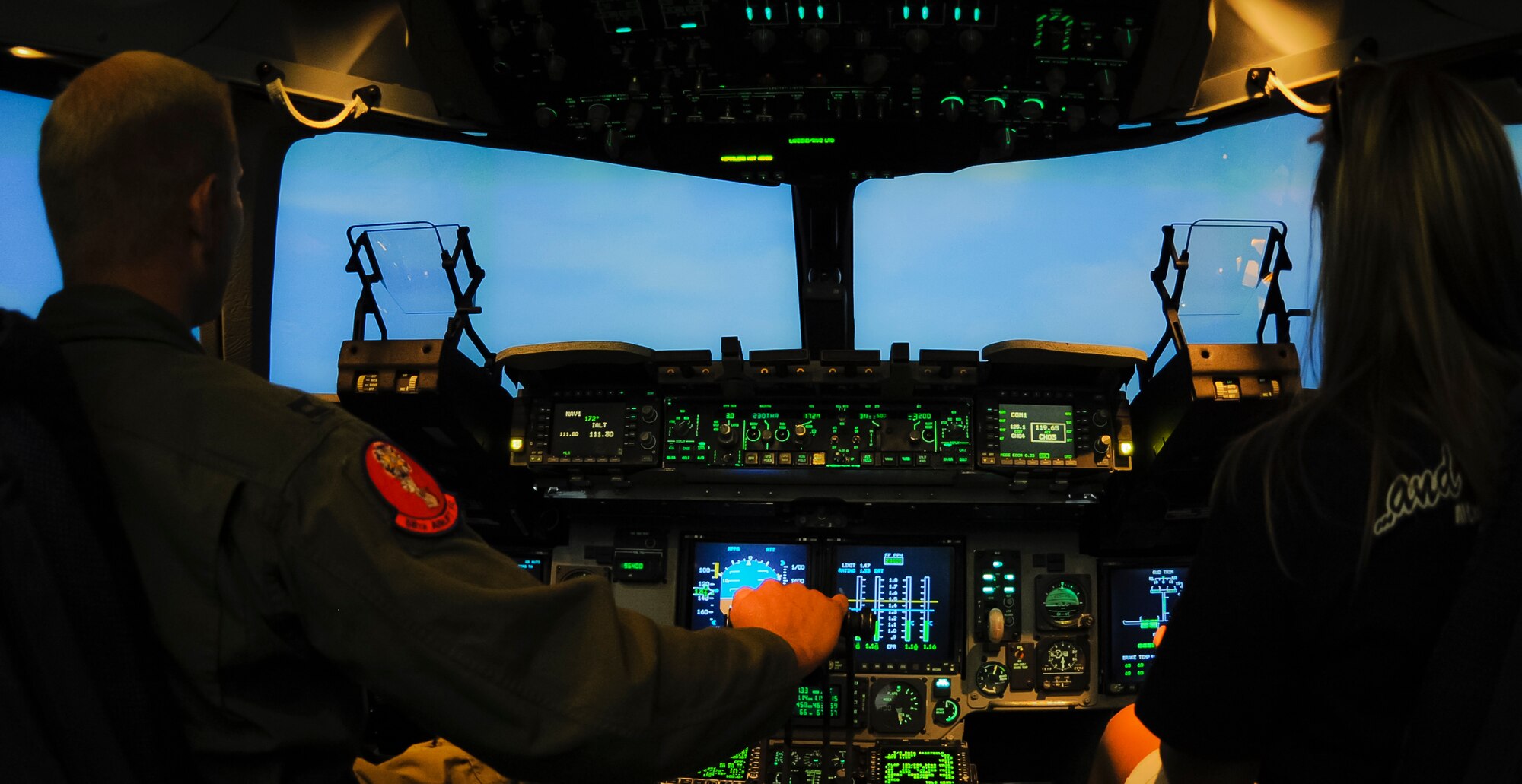 ALTUS AIR FORCE BASE, Okla. – U.S. Air Force Capt. Steve King, 58th Airlift Squadron instructor pilot, teaches Kathy Darby, Altus High School librarian, how to fly inside a U.S. Air Force C-17 Globemaster III simulator as part of STEM Faculty Development Day, Aug. 8. The tour was held to bring members of AHS onto base and teach them about the science, technology, engineering and math aspects of military training around base. (U.S. Air Force photo by Airman 1st Class Levin Boland / Released)