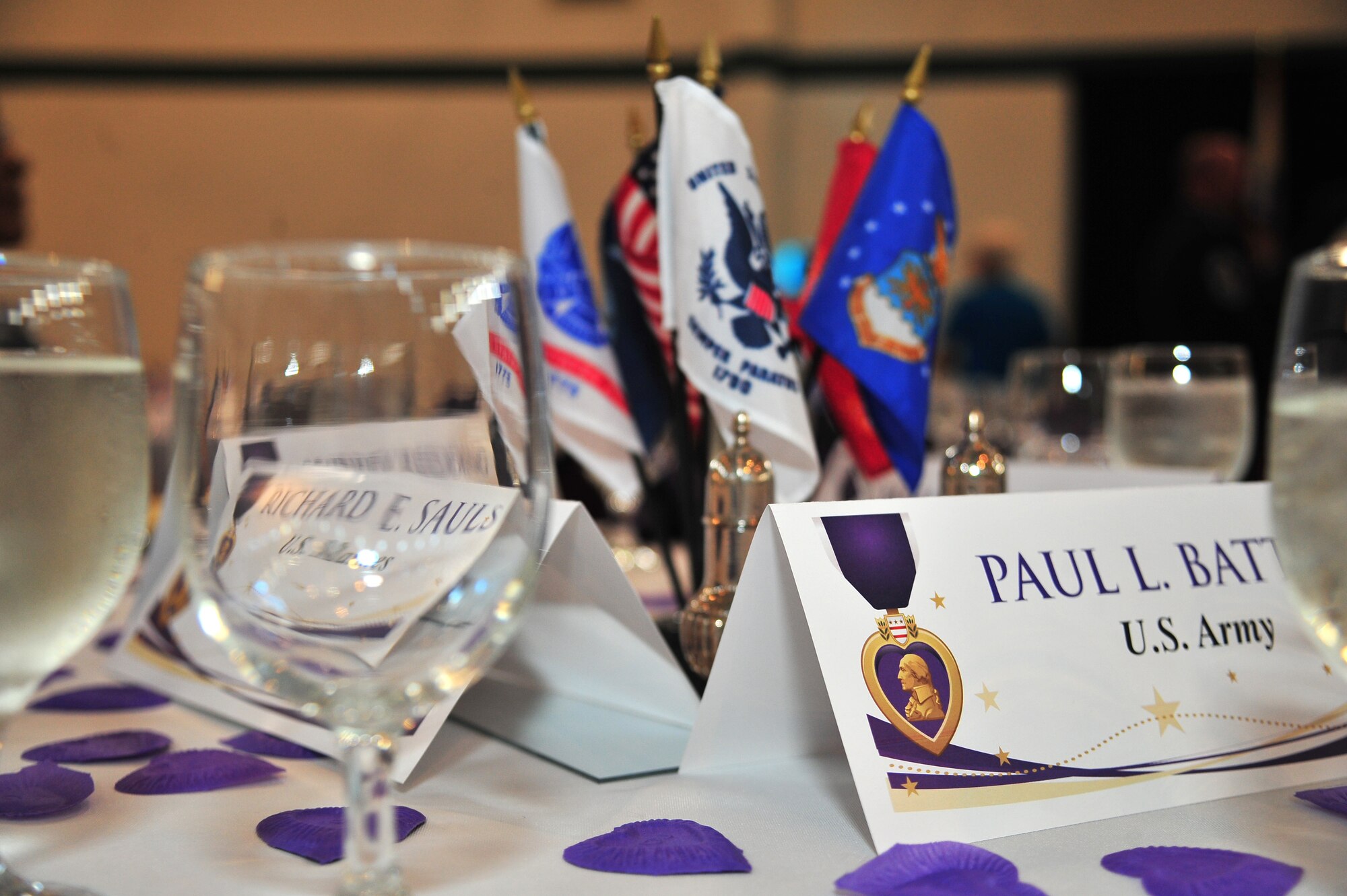 A table lays set during a ceremony honoring Purple Heart medal recipients at the First Church in Goldsboro, N.C., Aug. 6, 2013. According to the Air Force Personnel Center, Randolph Air Force Base, Ohio, the Purple Heart is awarded to Service members for wounds or death as a result of an act of any opposing armed force, an international terrorist attack or military operations while serving as part of a peacekeeping force. (U.S. Air Force photo by Senior Airman Aubrey White/Released