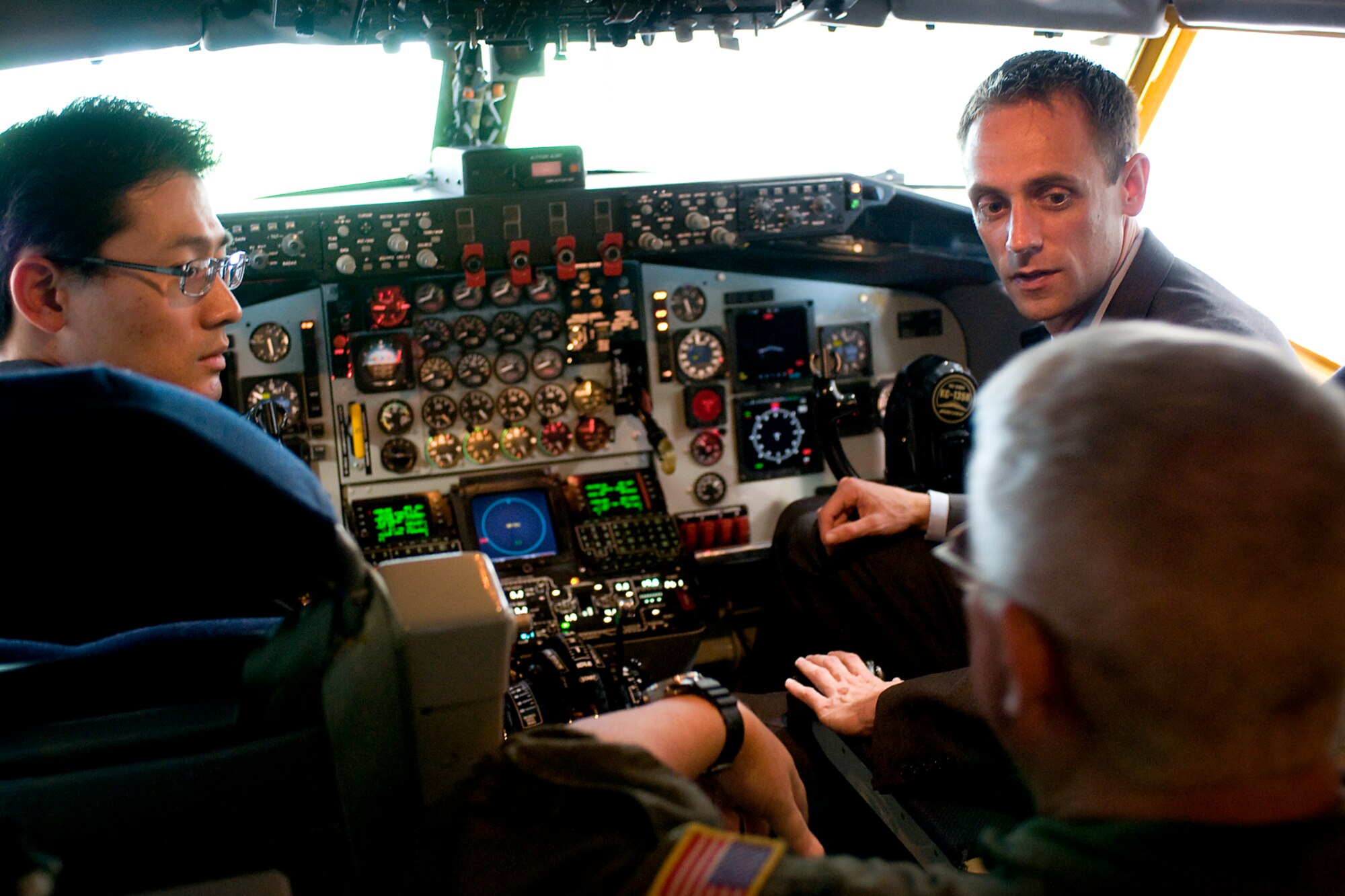 Andrew Lattanner, a legislative director, and David Park, a legislative correspondent, talk with Col. Don Buckley, 434th Air Refueling Wing commander, in the cockpit of a KC-135R Stratotanker during their visit to Grissom Air Reserve Base, Ind., Aug. 8, 2013. During their visit, the staffers were given a mission briefing and tour that included visits to a KC-135 static display, Grissom's Radar Approach Control facility, Grissom's air traffic control tower, a KC-135 simulator and Grissom's new boom operator weapon system trainer.  (U.S. Air Force photo/Tech. Sgt. Mark R. W. Orders-Woempner)
