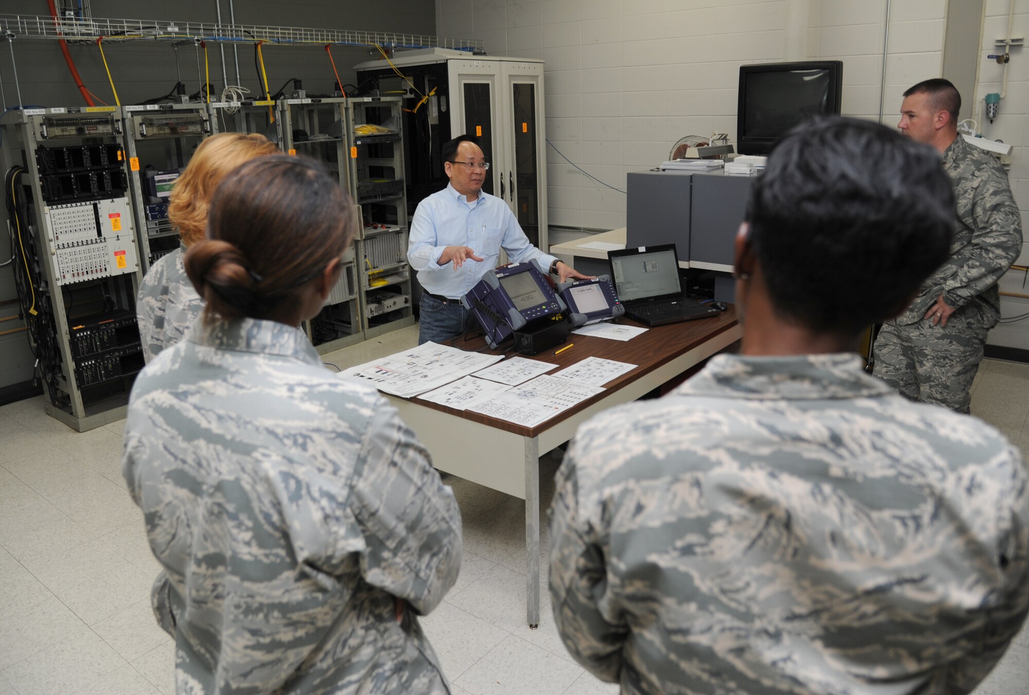 Peter Bui, 85th Engineering Installation Squadron telecommunications engineer, briefs 81st Training Wing leadership on a spectrum analyzer used for testing fiber optic cable during an 81st TRW leadership tour of the 85th EIS Aug. 8, 2013, at Maltby Hall, Keesler Air Force Base, Miss.  The purpose of the tour was to educate leadership on the unique services and day-to-day operations of the Air Force’s only active duty engineering installation squadron.  (U.S. Air Force photo by Kemberly Groue)