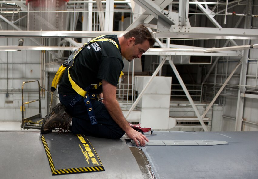 Sean Lucara, Boeing Company B-1 structural analysis engineer, attaches A-20 doubling straps to the backbone of the B-1 during a structural modification at Ellsworth Air Force Base, S.D., Aug. 6, 2013. The modifications will nearly double the lifespan of the B-1 and increase combat capabilities.  (U.S. Air Force photo by Airman 1st Class Alystria Maurer/Released)