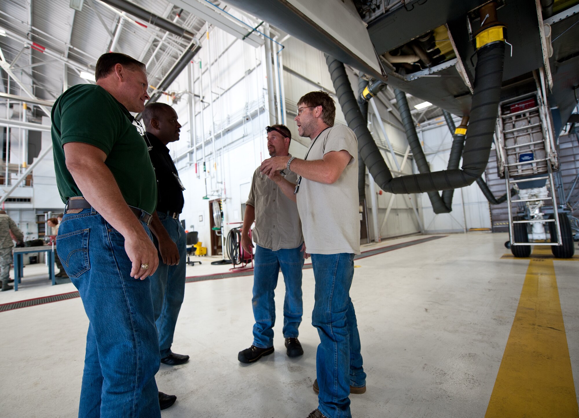 Members of the 28th Aircraft Maintenance Squadron contract field team (right) discuss details of the B-1 temporary modification with members of the Boeing Company (left) at Ellsworth Air Force Base, S.D., Aug. 6, 2013. Adding these upgrades will modernize and increase the lifespan of the B-1, enhancing its mission capability and effectiveness. (U.S. Air Force photo by Airman 1st Class Alystria Maurer/Released)