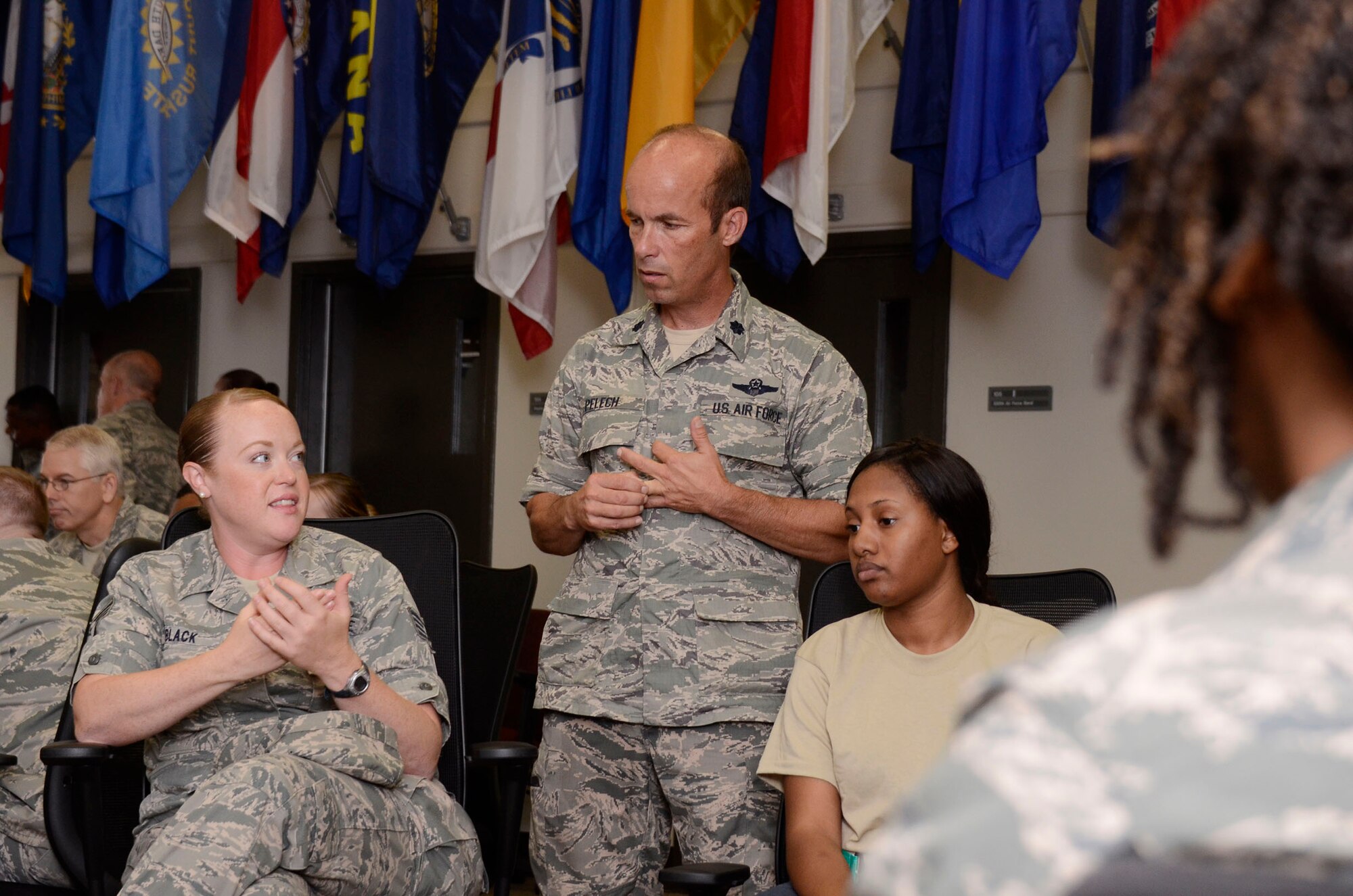 Staff Sgt. Lindsey Black, 94th Airlift Wing Public Affairs combat correspondant, and Airmen and members of the 94th Airlift Wing Development and Training Flight participate in individual discussions during Wingman Day 2013 at the Finch Building, Dobbins Air Reserve Base, Ga. Aug. 4. Various questions were posed to the groups, including, “If you did not need the money, what would you do for work?” Airmen took a pause from day-to-day mission duties and focused on unit wellness and getting to know each other a little better. (U.S. Air Force photo/Don Peek)