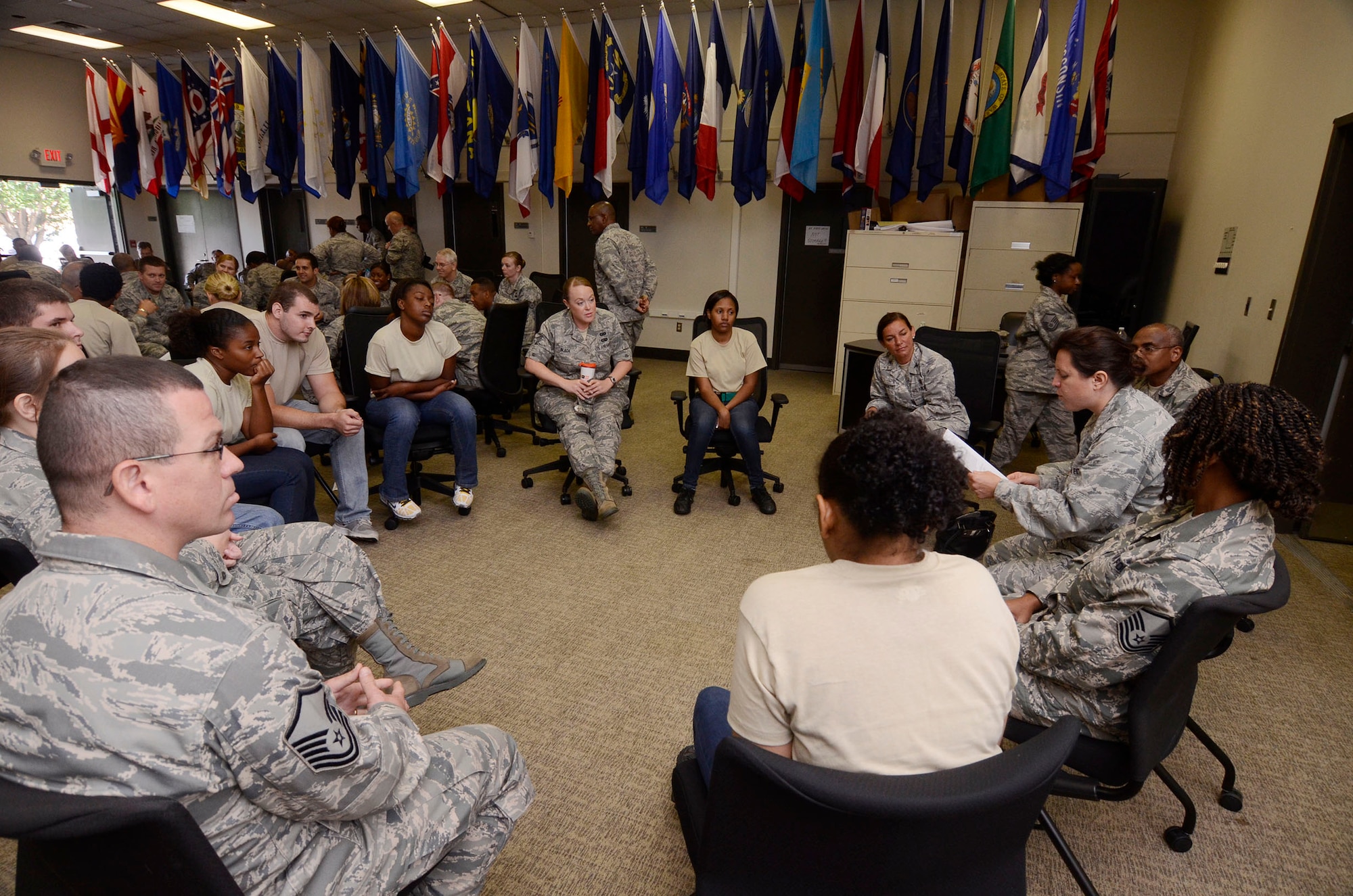 Airmen and members of the 94th Airlift Wing Development and Training Flight are separated into small groups for individual discussions during Wingman Day 2013 at the Finch Building, Dobbins Air Reserve Base, Ga. Aug. 4. Various questions were posed to the groups, including, “If you did not need the money, what would you do for work?” Airmen took a pause from day-to-day mission duties and focused on unit wellness and getting to know each other a little better. (U.S. Air Force photo/Don Peek)