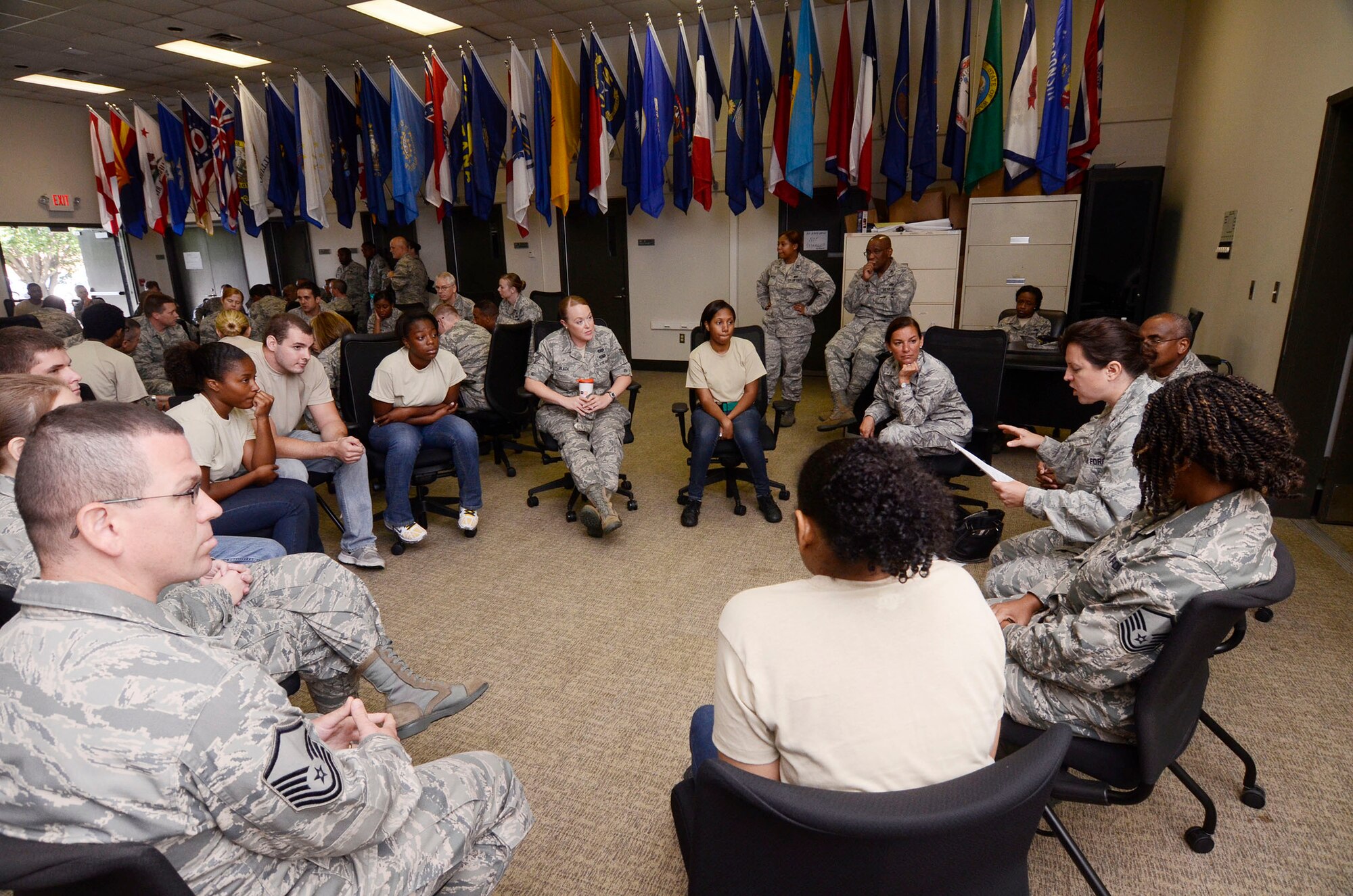 Airmen and members of the 94th Airlift Wing Development and Training Flight are separated into small groups for individual discussions during Wingman Day 2013 at the Finch Building, Dobbins Air Reserve Base, Ga. Aug. 4. Various questions were posed to the groups, including, “If you did not need the money, what would you do for work?” Airmen took a pause from day-to-day mission duties and focused on unit wellness and getting to know each other a little better. (U.S. Air Force photo/Don Peek)