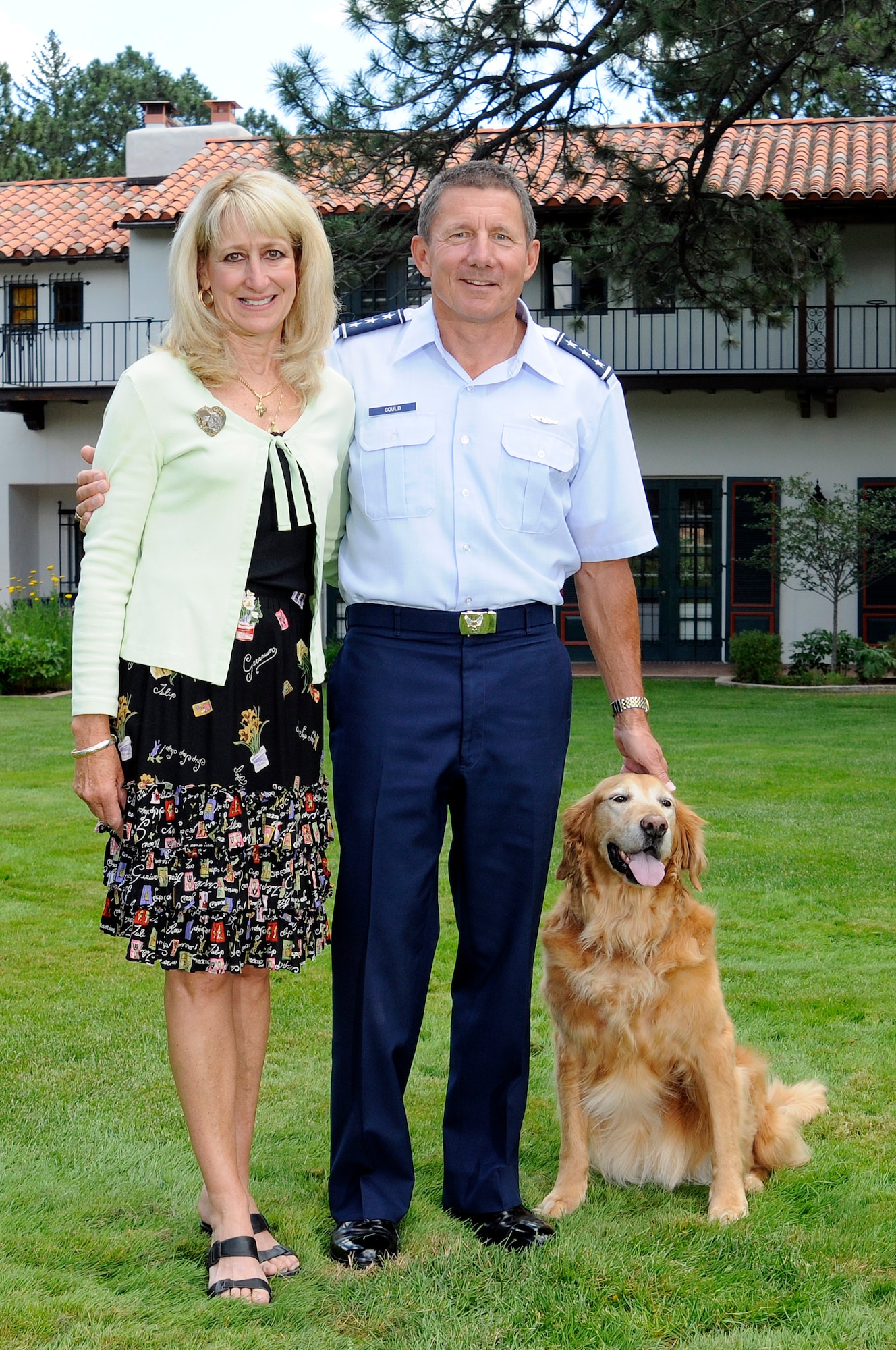Lt. Gen. Mike Gould (right) and his wife, Paula, pose for a family portrait with their dog, Aspen, Aug. 26, 2009 outside the Carlton House, their official Academy residence. (U.S. Air Force Photo/Mike Kaplan)