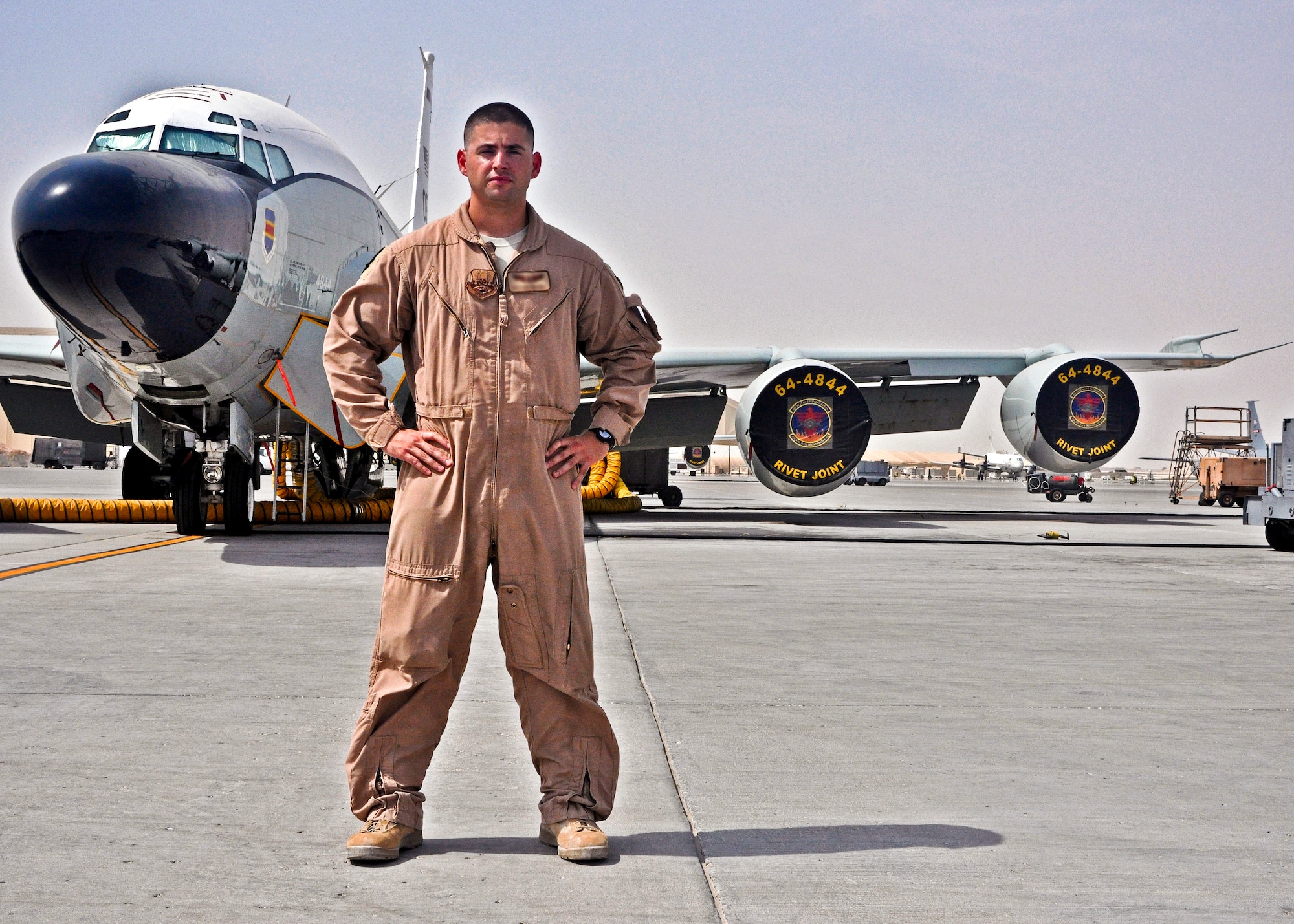 Staff Sgt. Chris poses in front of the RC-135 Rivet Joint at the 379th Air Expeditionary Wing in Southwest Asia, July 16, 2013. Chris is a career enlisted aviator who has flown more than 2,000 hours and more than 400 combat sorties, and is assigned to Offutt Air Force Base, Neb. (U.S. Air Force photo/1st Lt. Susan Harrington)