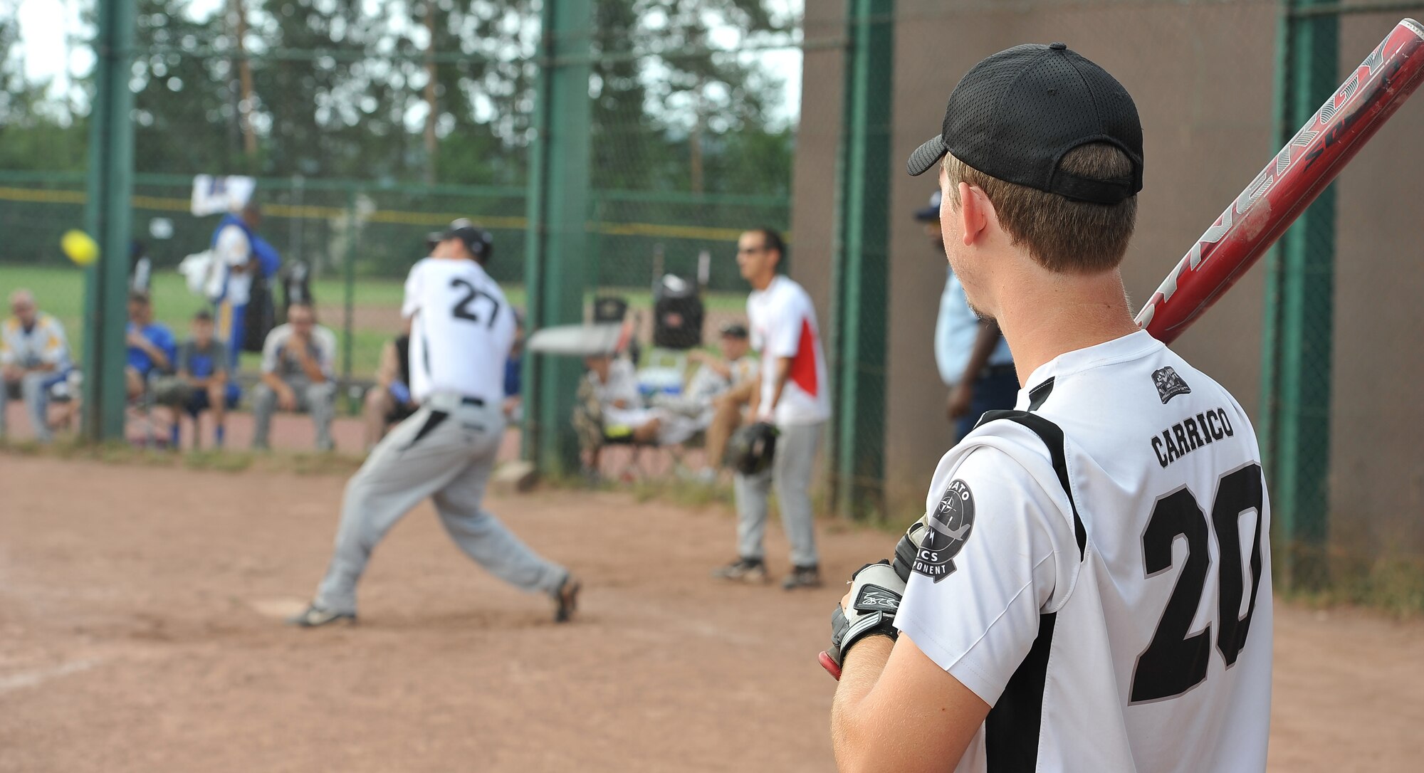 A player from the Geilenkirchen Hitmen waits his turn at bat, July 9, 2013, Ramstein Air Base, Germany. The Ramstein Men’s Varsity Softball team hosted the largest tournament in Europe. Twenty-one teams, 15 men’s and six women’s teams competed from all over the region. These teams gathered together to claim victory. (U.S. Air Force photo/Airman Dymekre Allen)
