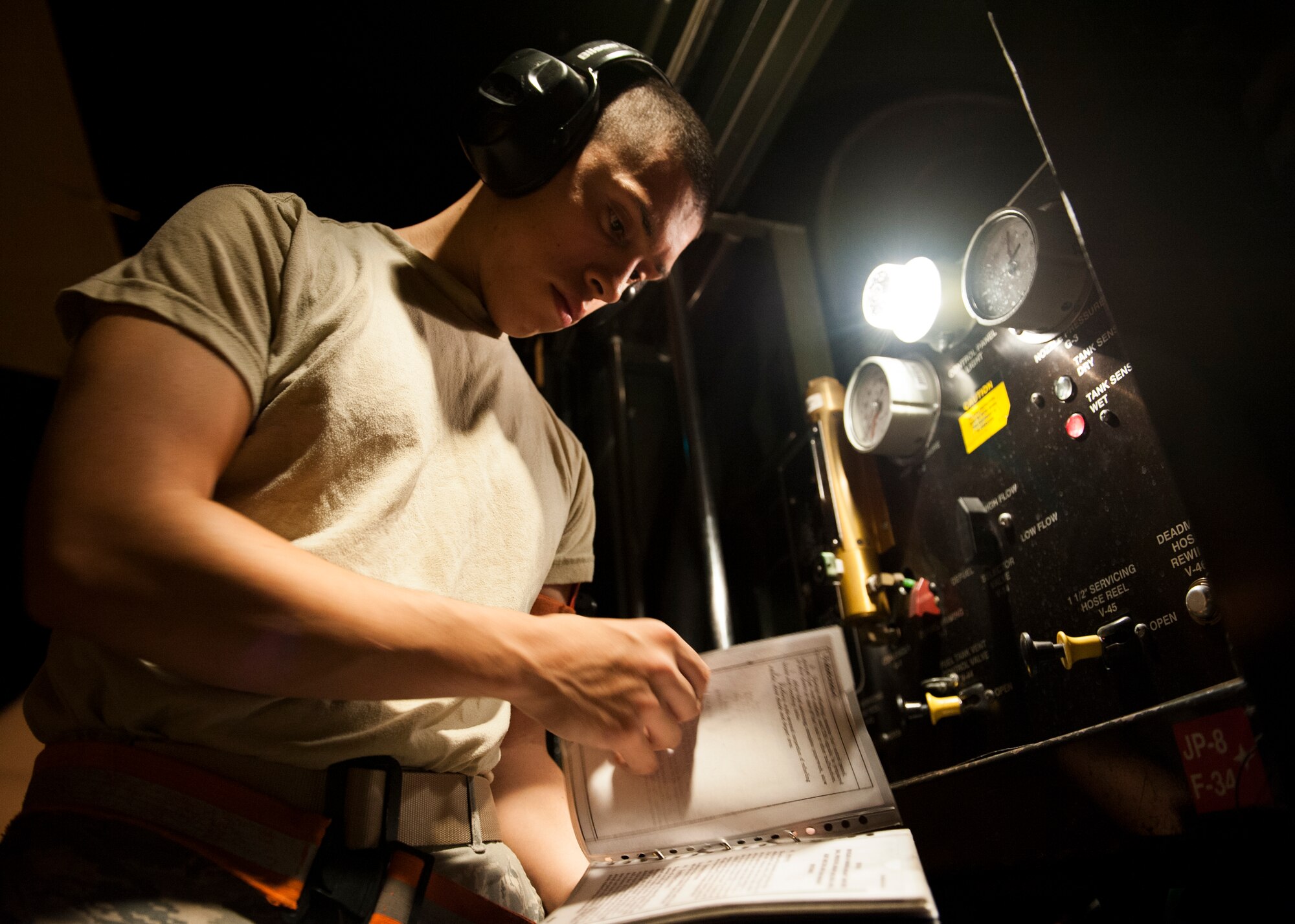 Senior Airman Miguel Pelayo, 86th Logistics Readiness Squadron fuels distribution operator, TDY from Ramstein Air Base, Germany, reviews a checklist during a night refueling operation Aug. 6, 2013, at Incirlik AB. The Logistics Compliance Assessment Program inspection team will evaluate 39th LRS support equipment and programs. (U.S. Air Force photo by Senior Airman Chase Hedrick/Released)