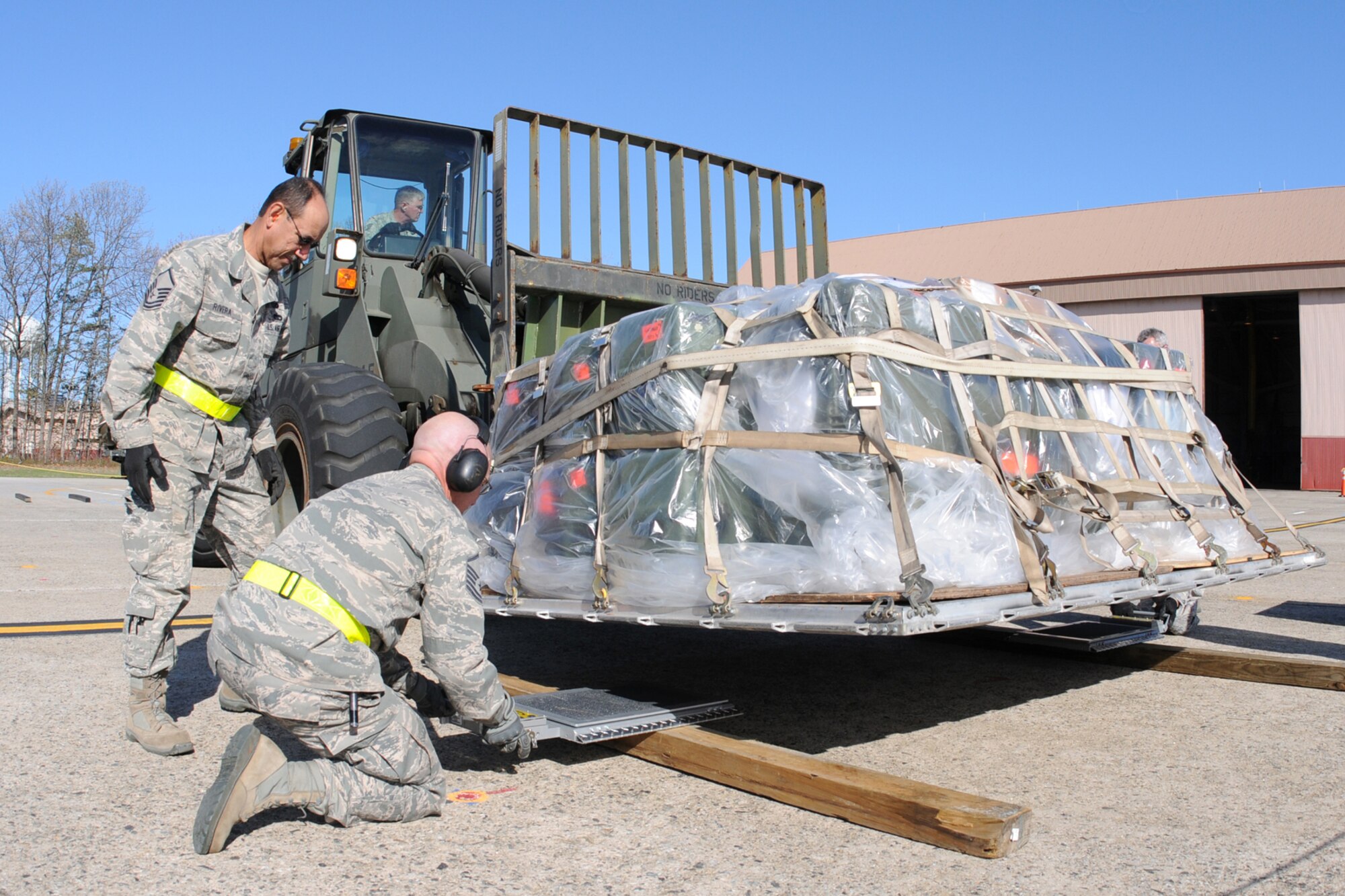 N.H. Air National Guard Master Sgt. Cesar Rivera (standing) and Master Sgt. Mark R. Rix process cargo during a readiness training exercise in preparation for an upcoming inspection planned for later this year, May 5, 2013, Pease Air National Guard Base, N.H. (U.S. Air National Guard photo by Staff Sgt. Curtis J. Lenz/Released)