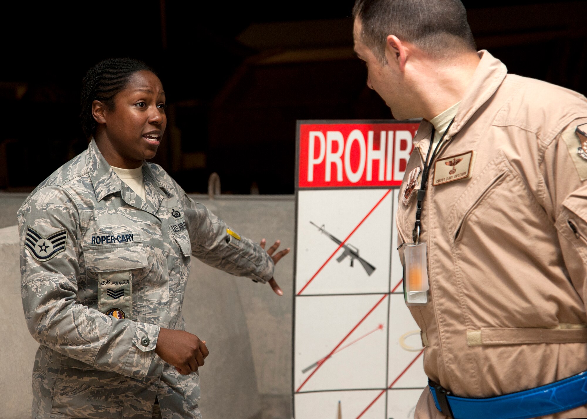 Staff Sgt. Eneida X. Roper-Cary reminds service members to remove all prohibited items from their luggage before they proceed through customs the 379th Air Expeditionary Wing in Southwest Asia, Aug. 8, 2013. Roper-Cary is a 379th AEW Host Nation Coordination Cell customs and immigrations liaison deployed from Pope Army Airfield, Fort Bragg, N.C. (U.S. Air Force photo/Senior Airman Bahja J. Jones) 