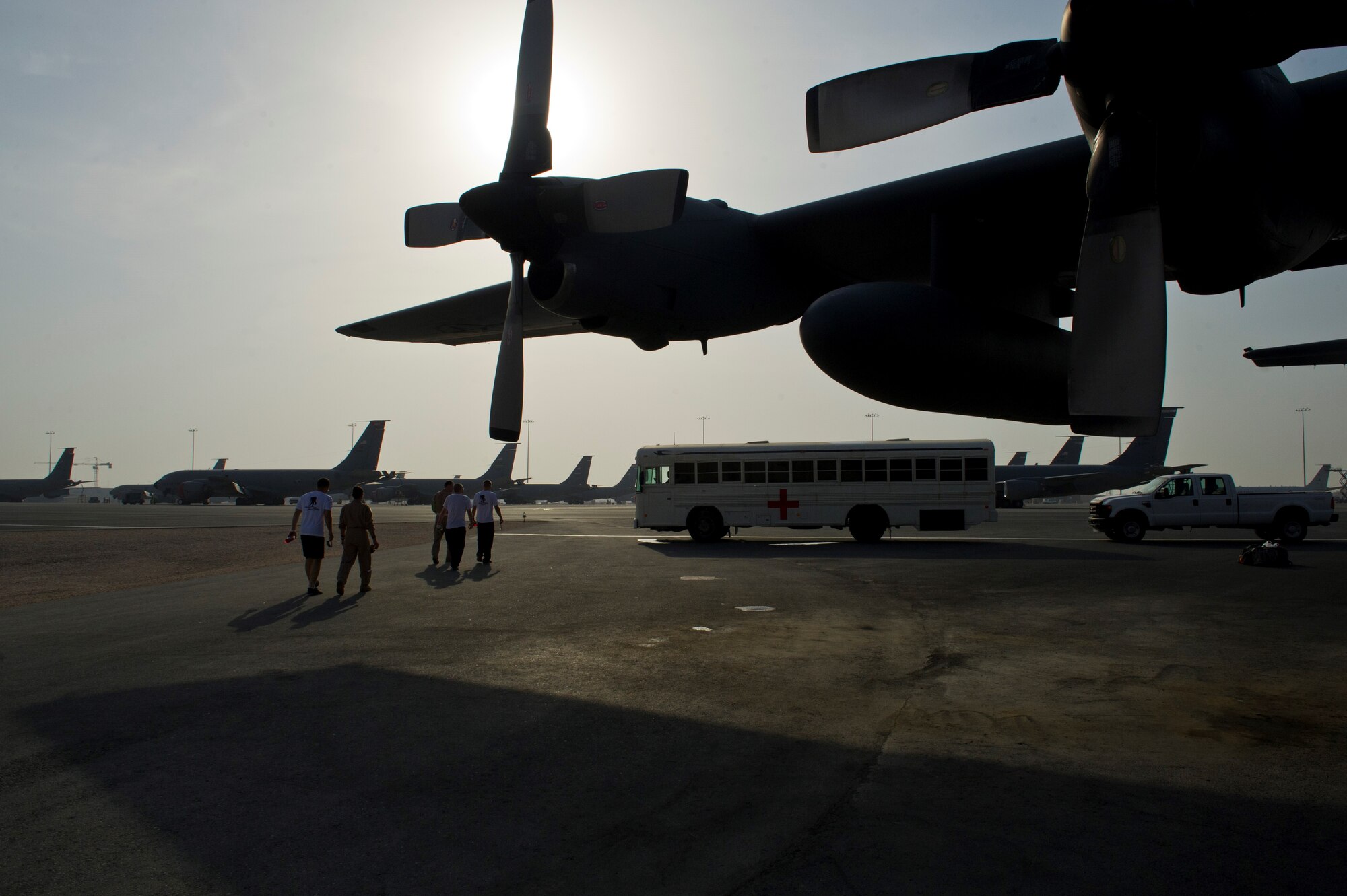 Members from the 379th Expeditionary Aeromedical Evacuation Squadron escort patients from a C-130 Hercules to a medical bus after returning from an aeromedical evacuation mission, July 20, 2013, at an undisclosed location in Southwest Asia. The EAES teams are needed to transport patients to medical facilities from remote deployed locations for additional treatment. (U.S. Air Force photo/Staff Sgt. Marleah Miller)