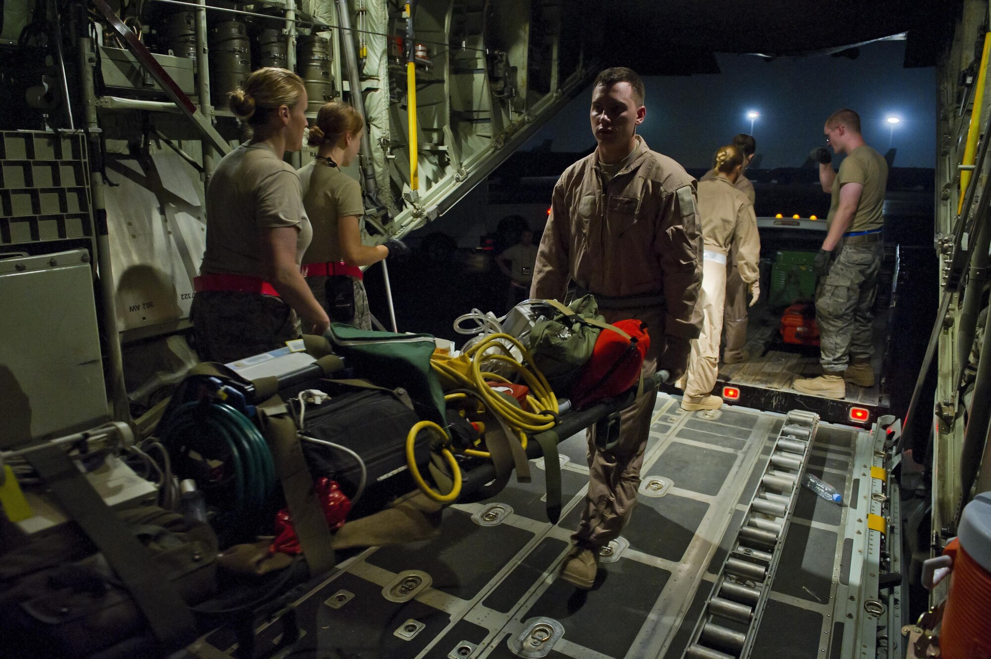 Members of the 379th Expeditionary Aeromedical Evacuation Squadron prep a C-130 Hercules before an aeromedical evacuation mission, July 19, 2013, at an undisclosed location in Southwest Asia. The EAES teams are needed to transport patients to medical facilities from remote deployed locations for additional treatment. (U.S. Air Force photo/Staff Sgt. Marleah Miller)