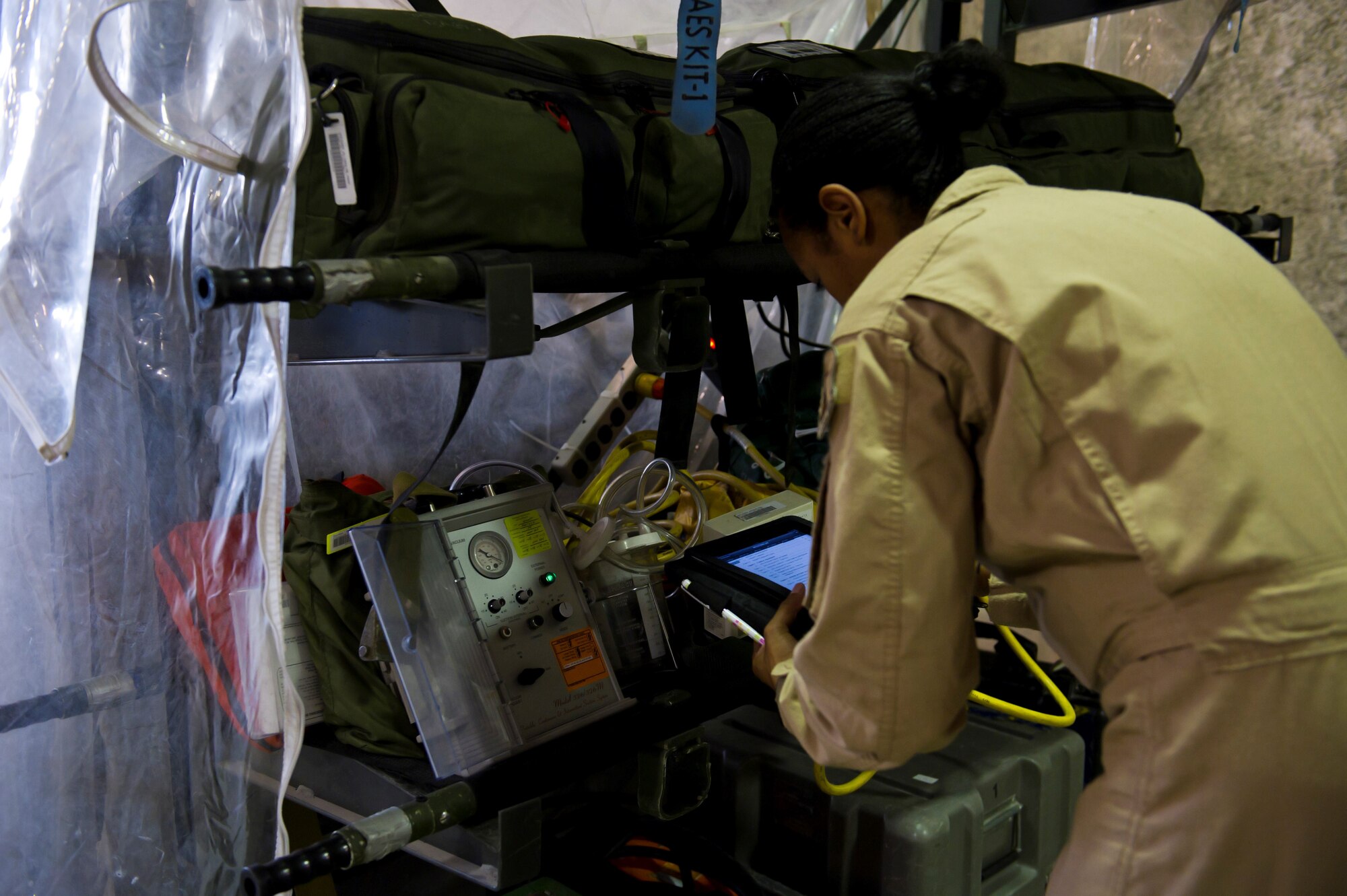 U.S. Air Force Staff Sgt. Yeneesa Simpson, 379th Expeditionary Aeromedical Evacuation Squadron medical technician, performs a routine checklist on items needed for a patient transfer mission, July 19, 2013, at an undisclosed location in Southwest Asia. The EAES teams are needed to transport patients to medical facilities from remote deployed locations for additional treatment. Simpson, a native of Athens, Tenn., is deployed from the 43rd Aeromedical Evacuation Squadron, Pope Air Force Base, NC. (U.S. Air Force photo/Staff Sgt. Marleah Miller)