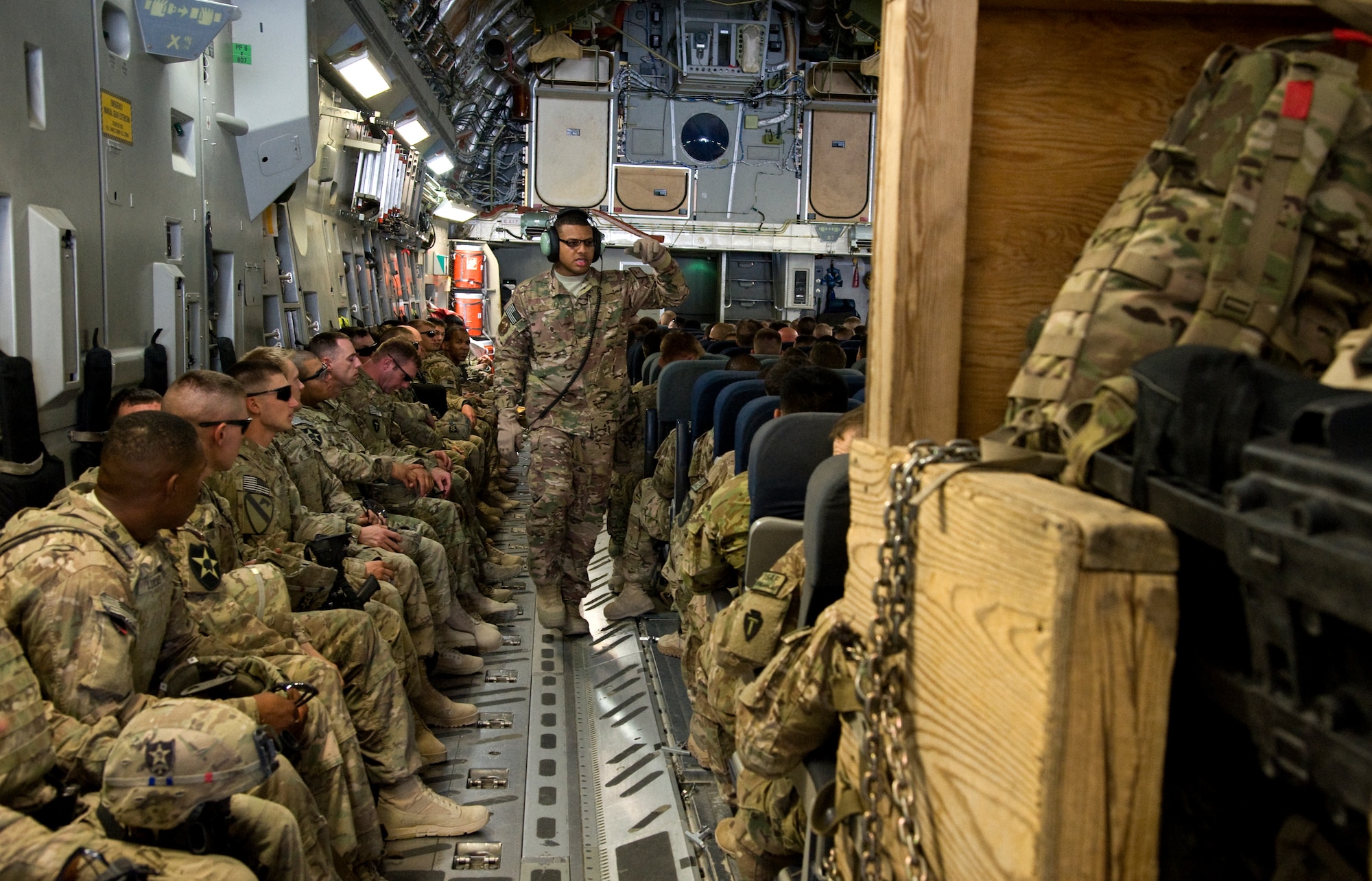 Tech. Sgt. Dequan Barthell, 817th Expeditionary Airlift Squadron Detachment 1, loadmaster evaluator, counts passengers on a C-17 Globemaster III prior to departure in Kandahar, Afghanistan July 25, 2013. The flight carried 137 deployed service members to Transit Center at Manas, Kyrgyzstan. (U.S. Air Force photo/Staff Sgt. Krystie Martinez)