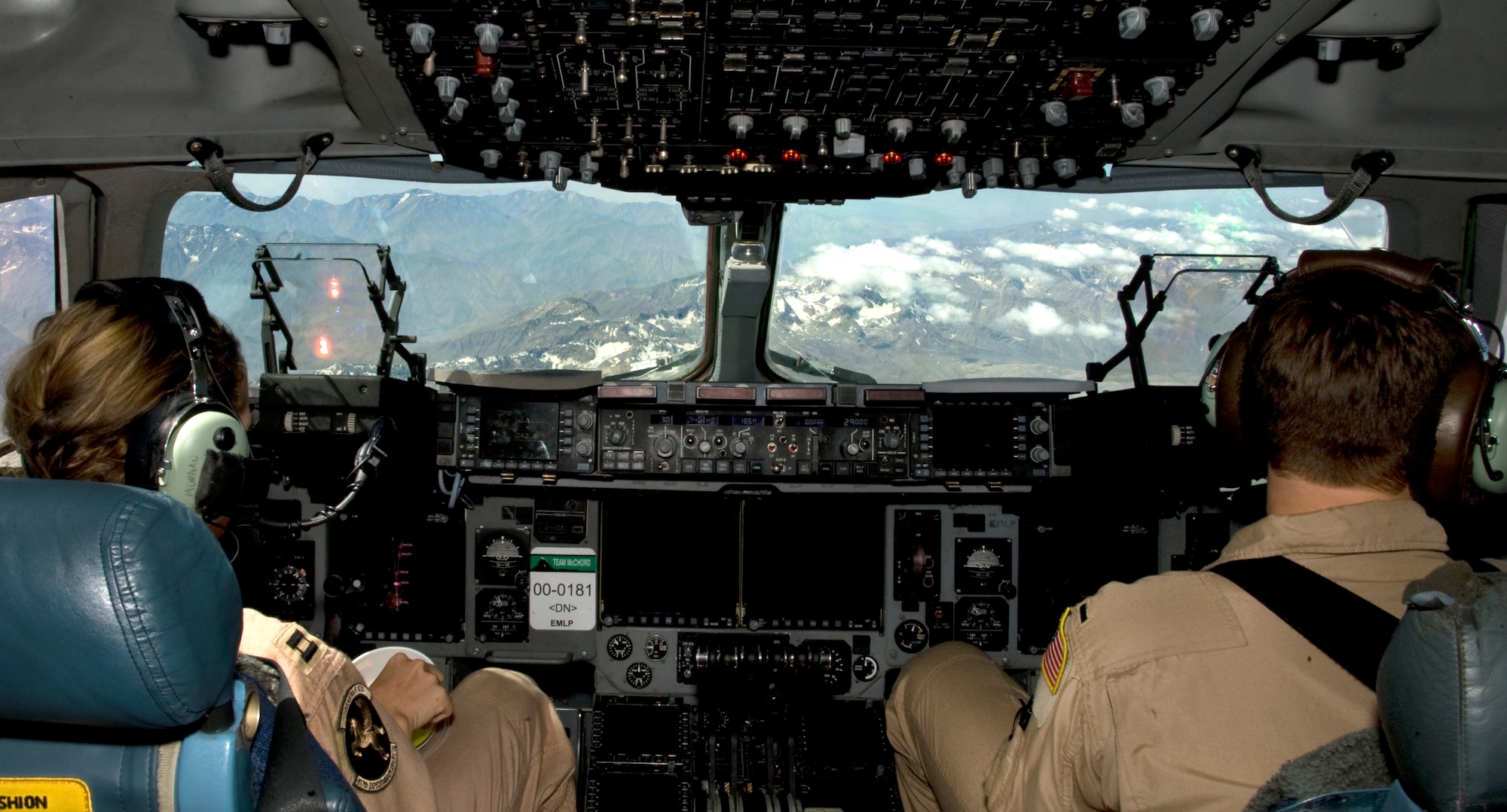 Captain Katrina Morgan, left, and 1st Lt. Jordan Bronson, right, 817th Expeditionary Airlift Squadron Detachment 1 C-17 Globemaster III pilots, remain vigilant during an onward movement and airlift mission over Kyrgyzstan, July 25, 2013. The pilots conduct system management during flight with the help of autopilot. Autopilot helps reduce pilot fatigue during deployed missions that may last up to 16 hours. Morgan is a native of Burien, Wash., and Bronson is a native of Spooner, Wis. They are deployed out of Joint Base Lewis-McChord, Wash. (U.S. Air Force photo/Staff Sgt. Krystie Martinez)