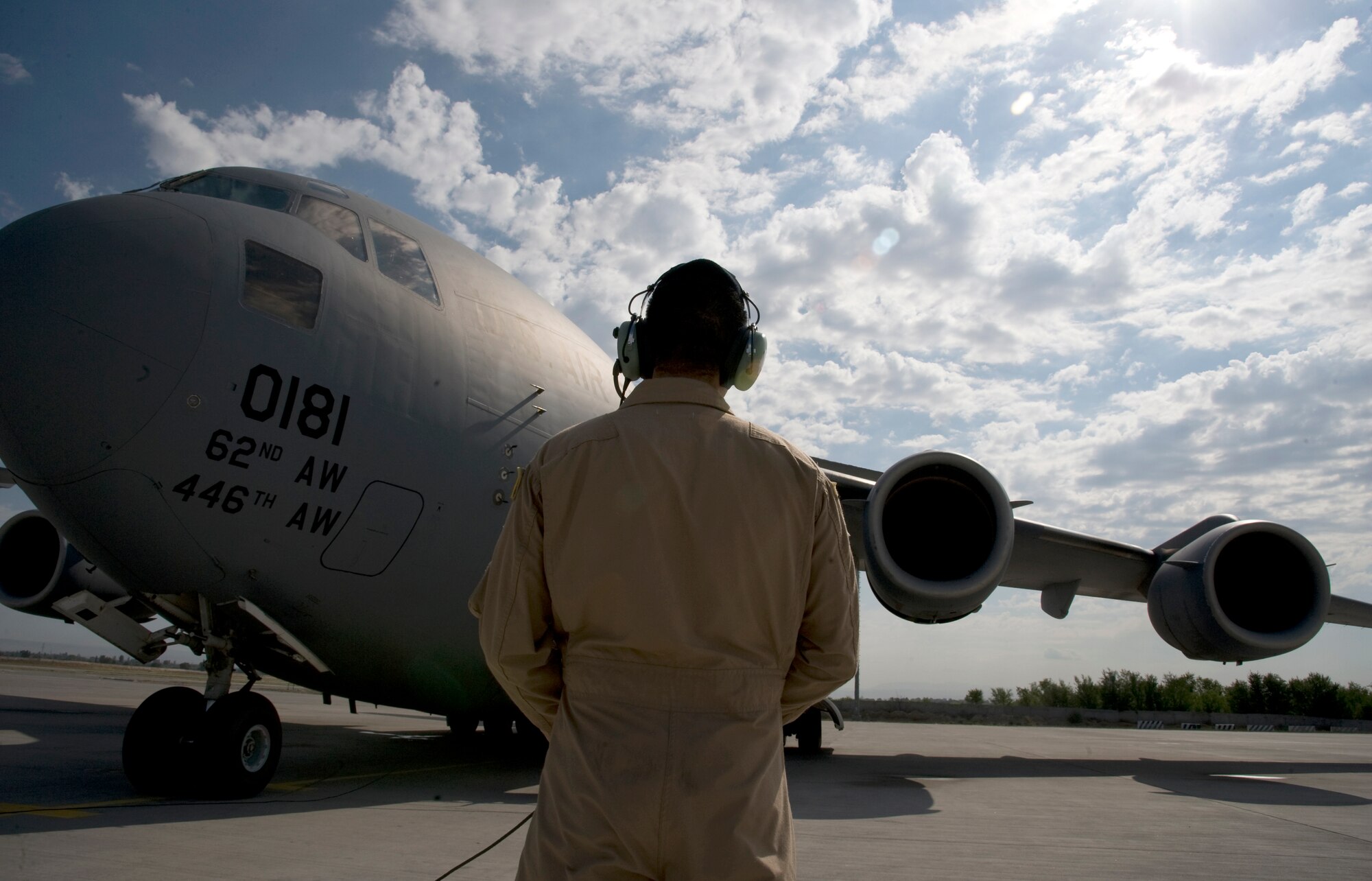 Senior Airman Justin Baez, 817th Expeditionary Airlift Squadron Detachment 1, loadmaster, observing the engine start of a C-17 Globemaster III at Transit Center at Manas, Kyrgyzstan, July 25, 2013. Each member of the four-person aircrew has specific responsibilities that are carried out by following thorough checklists. A loadmaster observes engine start in order to alert the pilots and passengers in case of an emergency. Baez is deployed from Joint Base Lewis-McChord, Wash., and is a native of El Paso, Texas. (U.S. Air Force photo/Staff Sgt. Krystie Martinez)