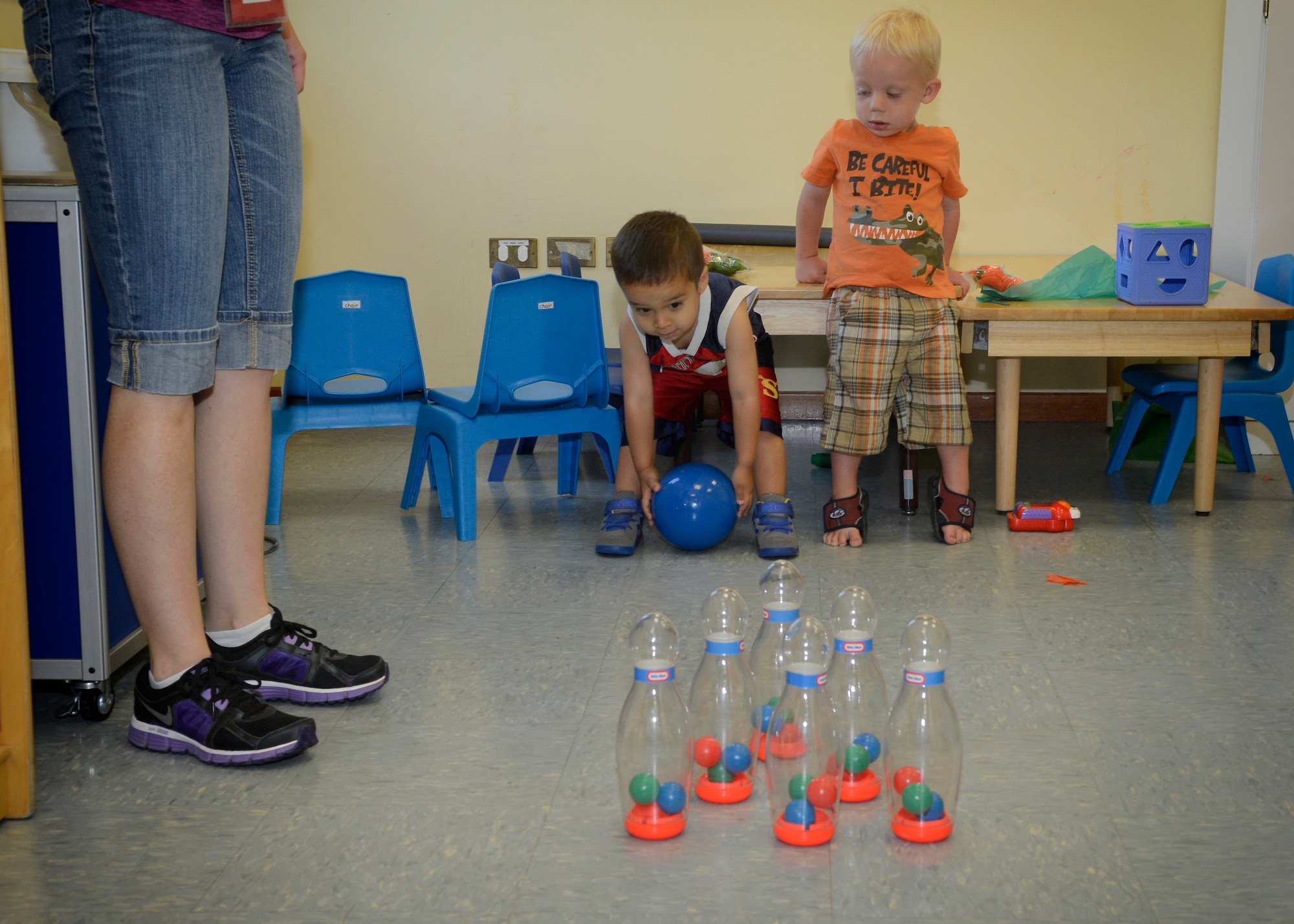 (From left) Heather Diaz stands aside as Xavier Diaz, 2, and Ryan Braithwaite, 2, take turns bowling at the Parent Co-Op Care center on Area 1, Aug. 6, 2013 at Aviano Air Base, Italy. Many stay-at-home parents use the program to find an outlet for doing things for themselves while also giving their children opportunities to interact with other children. (U.S. Air Force photo/Senior Airman Jessica Hines)