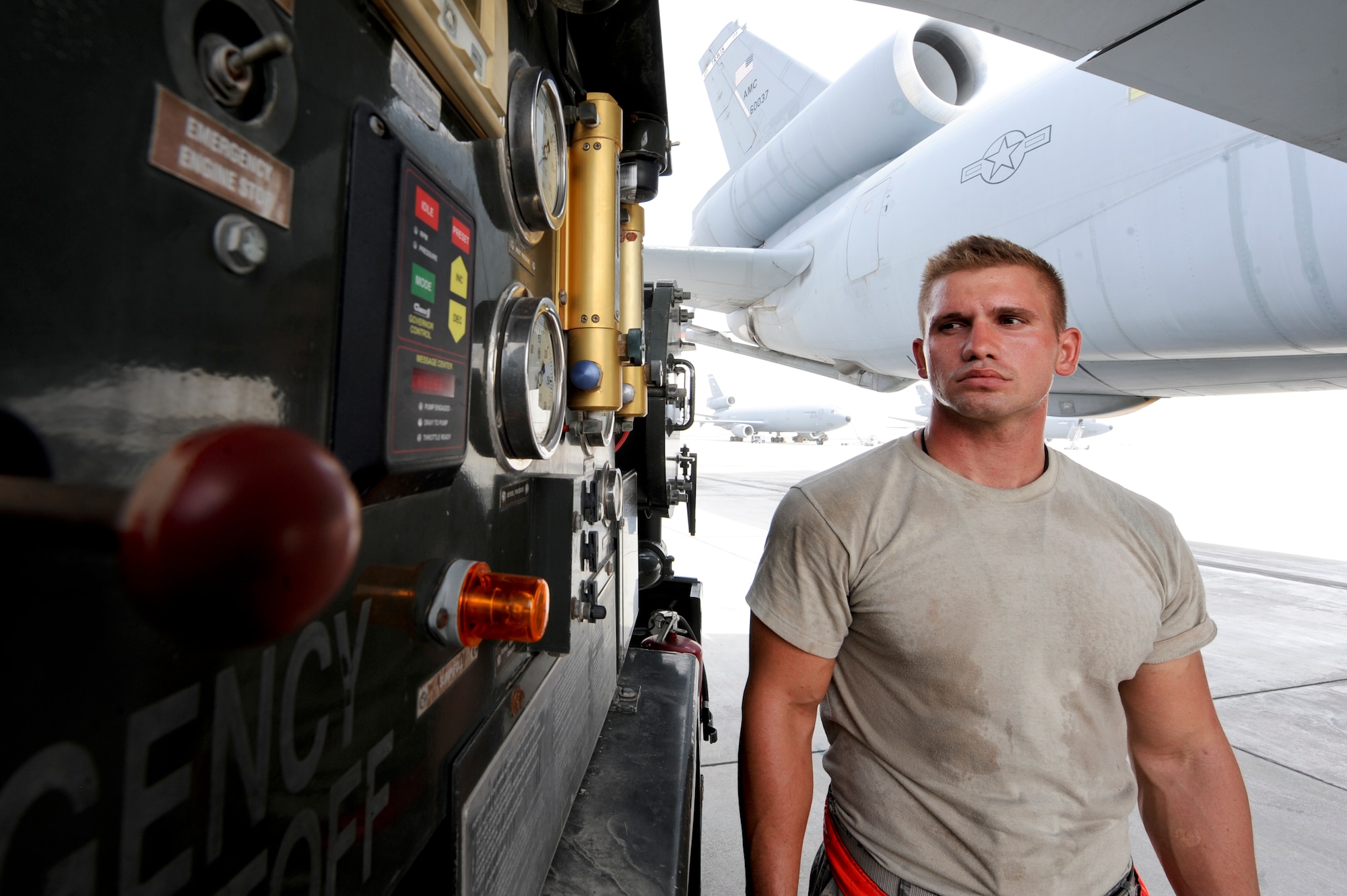 380th Expeditionary Logistic Readiness Squadron fuels technician, monitors hydrant and nozzle pressure while refueling a KC-10 Extender at an undisclosed location in Southwest Asia Aug. 8, 2013. Escobar works alongside KC-10 Extender crew chiefs during the refueling. Escobar is native to Dayton, Ohio and is deployed from Luke Air Force Base, Ariz. (U.S. Air Force photo by Staff Sgt. Joshua J. Garcia)