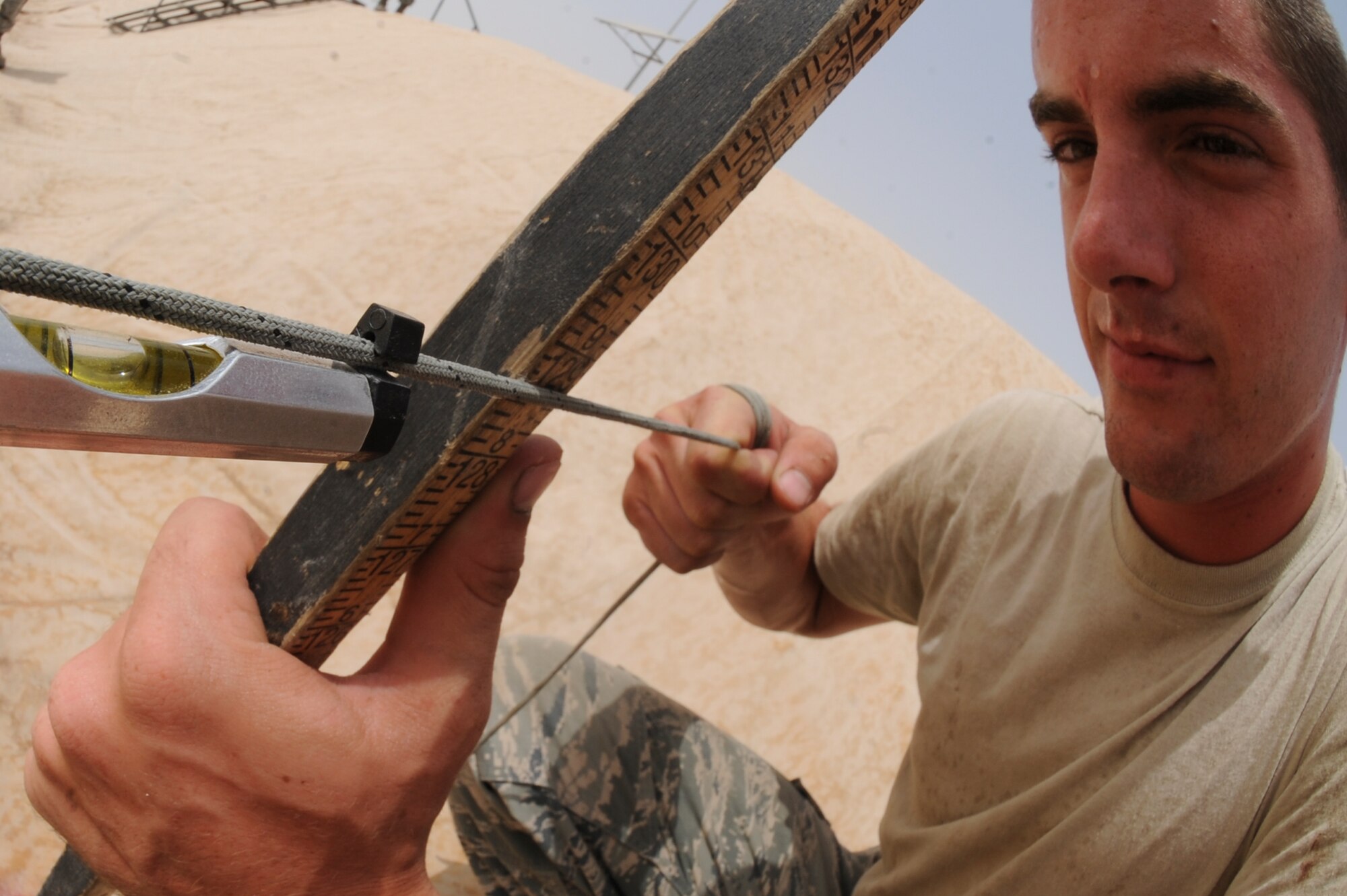 U.S. Air Force Airman 1st Class Zachary Williams, 380th Expeditionary Logistic Readiness Squadron fuels technician, measures the amount of fuel in a contingency fuel bladder at an undisclosed location in Southwest Asia August 8, 2013. The fuel is measured to ensure an accurate accountability of fuel being used by the wing. Williams is a native to the state of Georgia, and is deployed from Minot Air Force Base, N.D. (U.S. Air Force photo by Staff Sgt. Joshua J. Garcia)