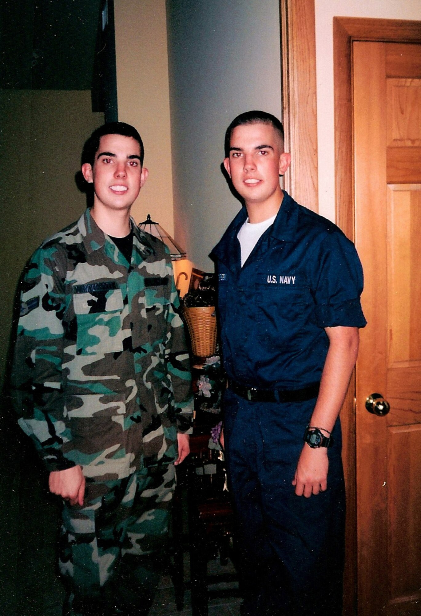 Andrew (L) and Matthew Van Dercreek, fraternal twins from Riverhead, N.Y., pose in their military uniforms in 2004 when they both began careers in the military.  Leap forward nine years and the brothers have since switched uniforms and branch of services.  Andrew is beginning a career as an air traffic controller in the Navy, Matthew is now an Air Force senior airman in the 107th Airlift Wing, Niagara Falls Reserve Station, N.Y.  Matthew is currently deployed to the 386th Expeditionary Operations Squadron at an undisclosed location in Southwest Asia.  (Courtesy photo) 