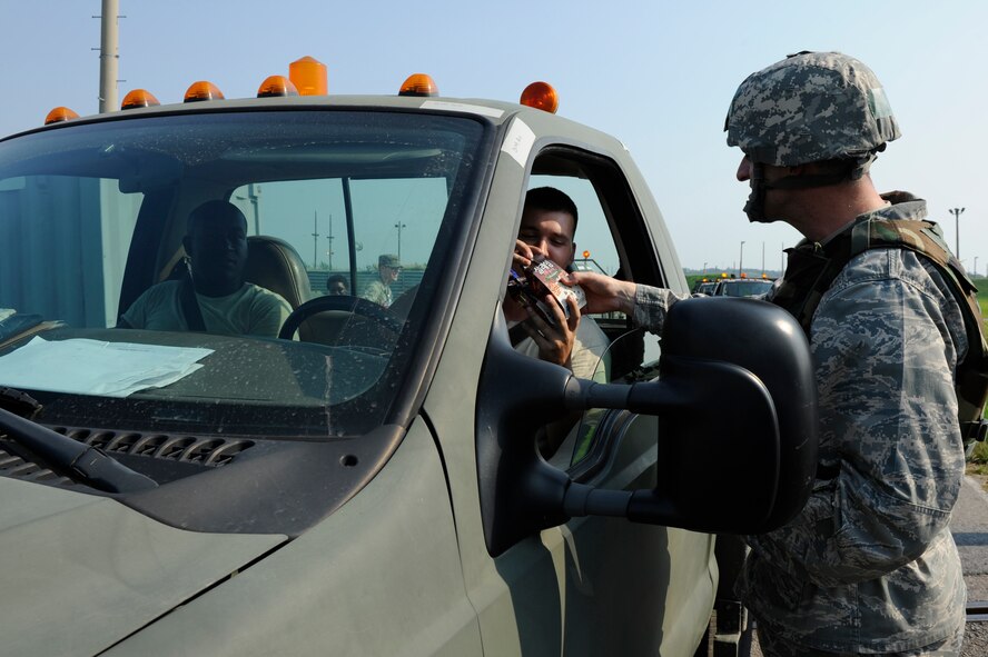 KUNSAN AIR BASE, Republic of Korea – Colonel S. Clinton Hinote, 8th Fighter Wing commander, greets 8th Maintenance Squadron members with milkshakes during exercise Beverly Midnight 13-3, Aug. 8, 2013. The Korean Veterans Association  donated more than 900 shakes to help Wolf Pack members beat the heat. (U.S. Air Force photo by Staff Sgt. Tong Duong/Released)