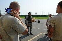 KUNSAN AIR BASE, Republic of Korea – Colonel S. Clinton Hinote, 8th Fighter Wing commander, speaks with 8th Maintenance Squadron ammo troops during exercise Beverly Midnight 13-3, Aug. 8, 2013. Hinote visited with and handed out milkshakes to help Airmen find temporary relief from the 100 degree weather. (U.S. Air Force photo by Staff Sgt. Tong Duong/Released)