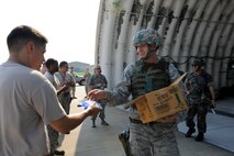 KUNSAN AIR BASE, Republic of Korea – Colonel S. Clinton Hinote, 8th Fighter Wing commander, hands out milkshakes to 80th Fighter Squadron crew chiefs during exercise Beverly Midnight 13-3, Aug. 8, 2013. The drinks were donated by the Korean Veterans Association to boost morale during the exercise. (U.S. Air Force photo by Staff Sgt. Tong Duong/Released)
