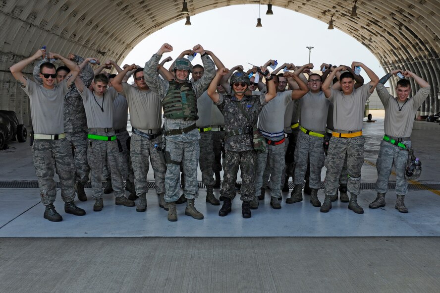 KUNSAN AIR BASE, Republic of Korea – Colonel S. Clinton Hinote, 8th Fighter Wing commander and Republic of Korea air force, Col. Min-Oh Seo, 38th Fighter Group commander, take a moment during exercise Beverly Midnight 13-3, Aug. 8, 2013 to “crush’em” with 80th Fighter Squadron crew chiefs. The commanders visited with 8th Security Forces Squadron and flight line personnel during the exercise to give accolades and answer questions. (U.S. Air Force photo by Staff Sgt. Tong Duong/Released)