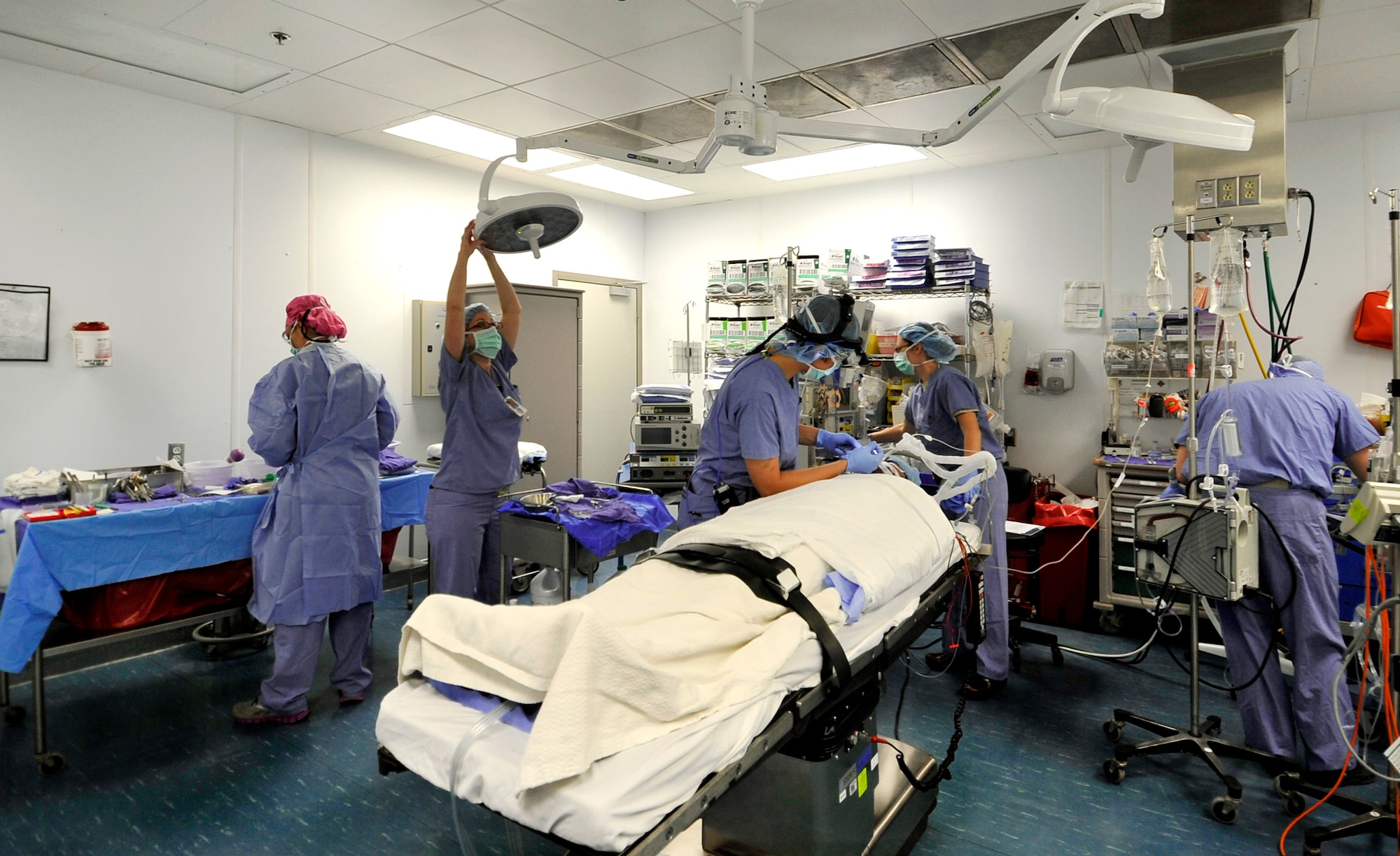 Major Jamie Swartz, an ear nose and throat surgeon, and her assistant, Staff Sgt. Robyn Wilcox, prepare a patient for an open septorhinoplasty on a patient in the Craig Joint Theater Hospital on Bagram Airfield, Afghanistan, July 22, 2013. The procedure performed separated his nose into a left and right side straightening the septum and bones, reducing the obstruction and allowing the patient to breathe better. The patient had problems breathing, headaches and pressure because of an obstruction inside his nose.   (U.S. Air Force photo/Staff Sgt. Stephenie Wade)