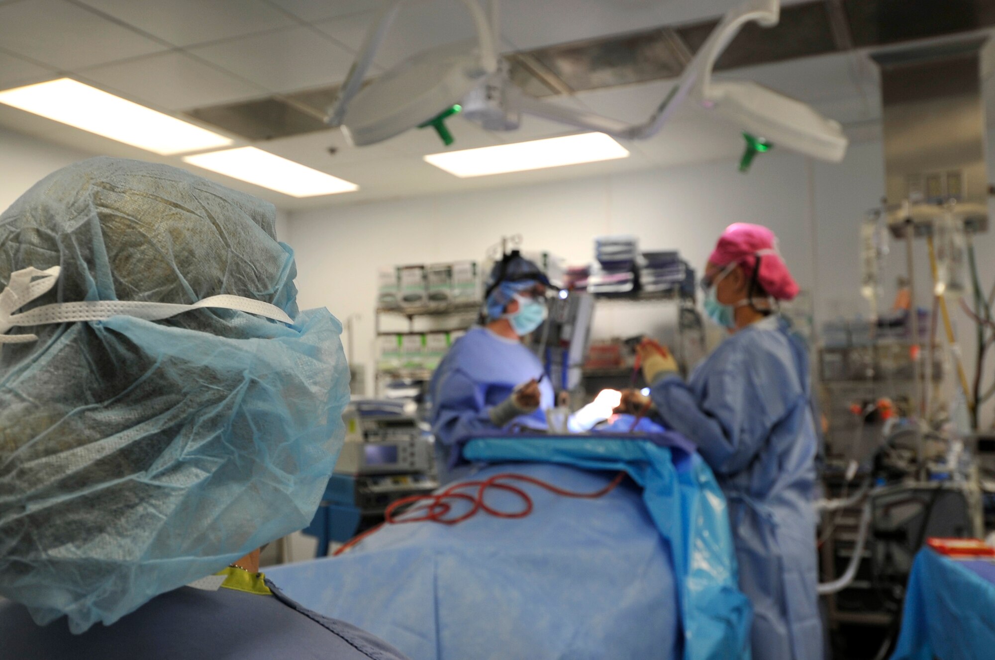 Major Jamie Swartz, an ear nose and throat surgeon, and her assistant, Staff Sgt. Robyn Wilcox, perform an open septorhinoplasty on a patient in the Craig Joint Theater Hospital on Bagram Airfield, Afghanistan, July 22, 2013. The procedure performed separated his nose into a left and right side straightening the septum and bones, reducing the obstruction and allowing the patient to breathe better. The patient had problems breathing, headaches and pressure because of an obstruction inside his nose. (U.S. Air Force photo/Staff Sgt. Stephenie Wade)