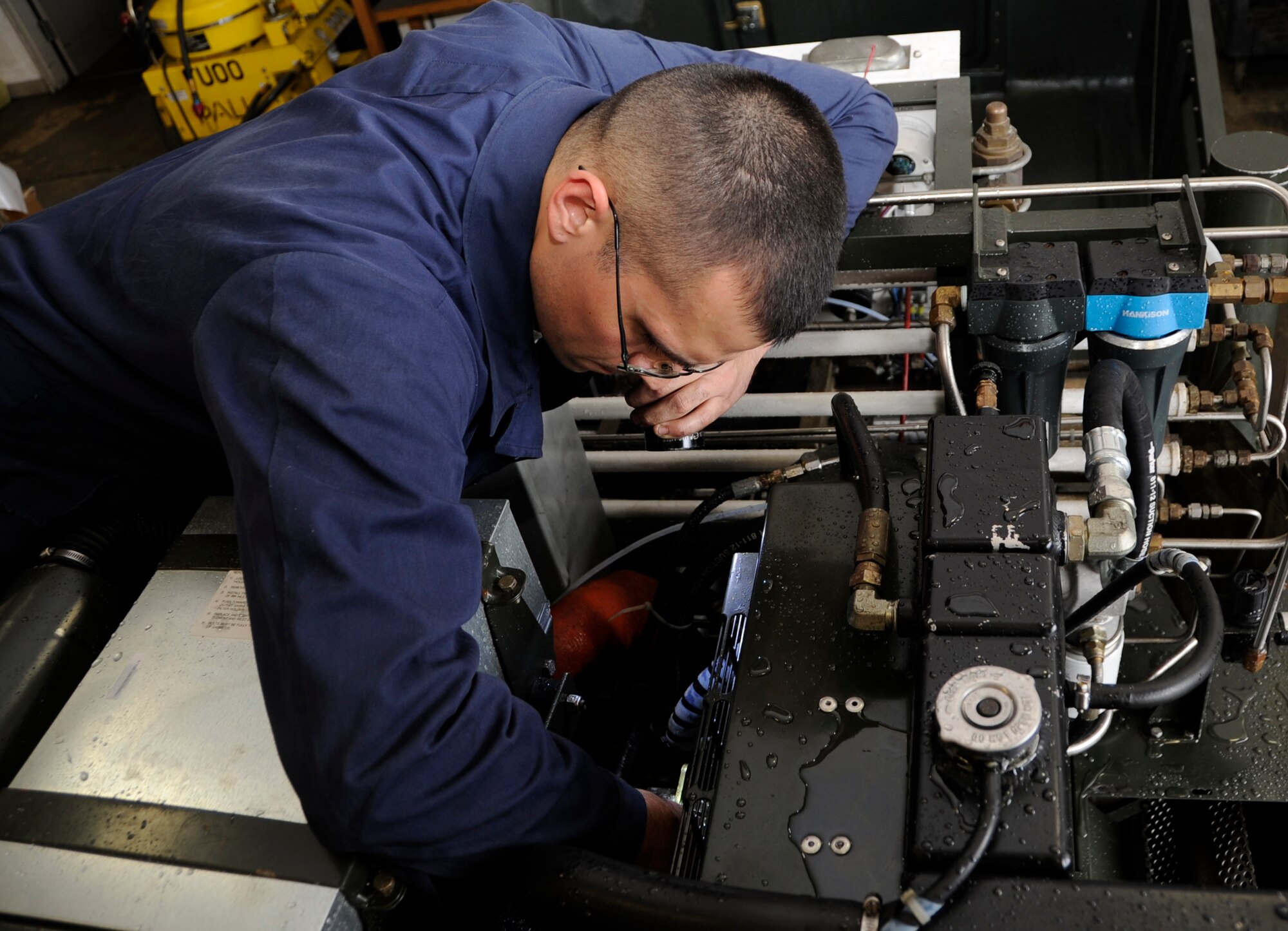 U.S. Air Force Staff Sgt. Brian McKinley, 35th Maintenance Squadron Aerospace Ground Equipment journeyman, inspects the fan belt on a generator as part of a phase-two periodic inspection at Misawa Air Base, Japan, Aug. 8, 2013. These generators are used frequently by maintenance personnel to produce power in the F-16 Fighting Falcons.  (U.S. Air Force photo by Airman 1st Class Kaleb Snay)