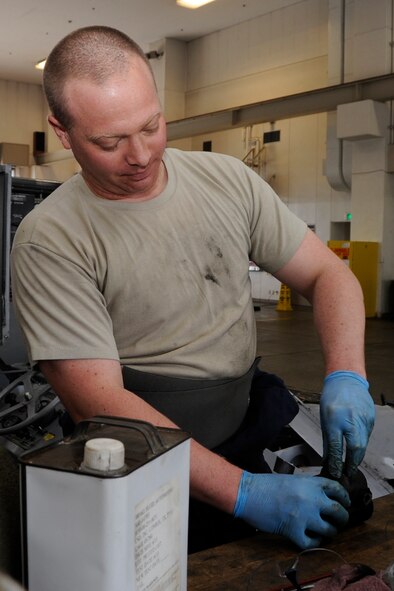 U.S. Air Force Staff Sgt. Darron Kucia, 35th Maintenance Squadron Aerospace Ground Equipment journeyman, inspects machine parts as part of a phase-two periodic inspection at Misawa Air Base, Japan, Aug. 8, 2013. A phase-two inspection involves dismantling equipment to see every component and determine what needs to be replaced or fixed. (U.S. Air Force photo by Airman 1st Class Kaleb Snay)