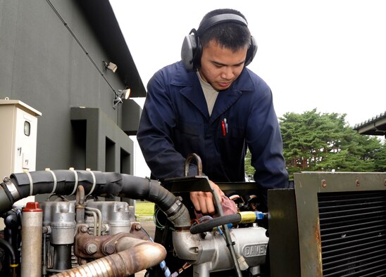 U.S. Air Force Staff Sgt. Cyril Serrano, 35th Maintenance Squadron Aerospace Ground Equipment journeyman, changes oil in a generator as part of a phase-two periodic inspection at Misawa Air Base, Japan, Aug. 8, 2013. AGE is responsible for maintaining the equipment that supplies electricity, as well as hydraulic pressure and air pressure, as planes receive maintenance and prepare for flight. (U.S. Air Force photo by Airman 1st Class Kaleb Snay)
