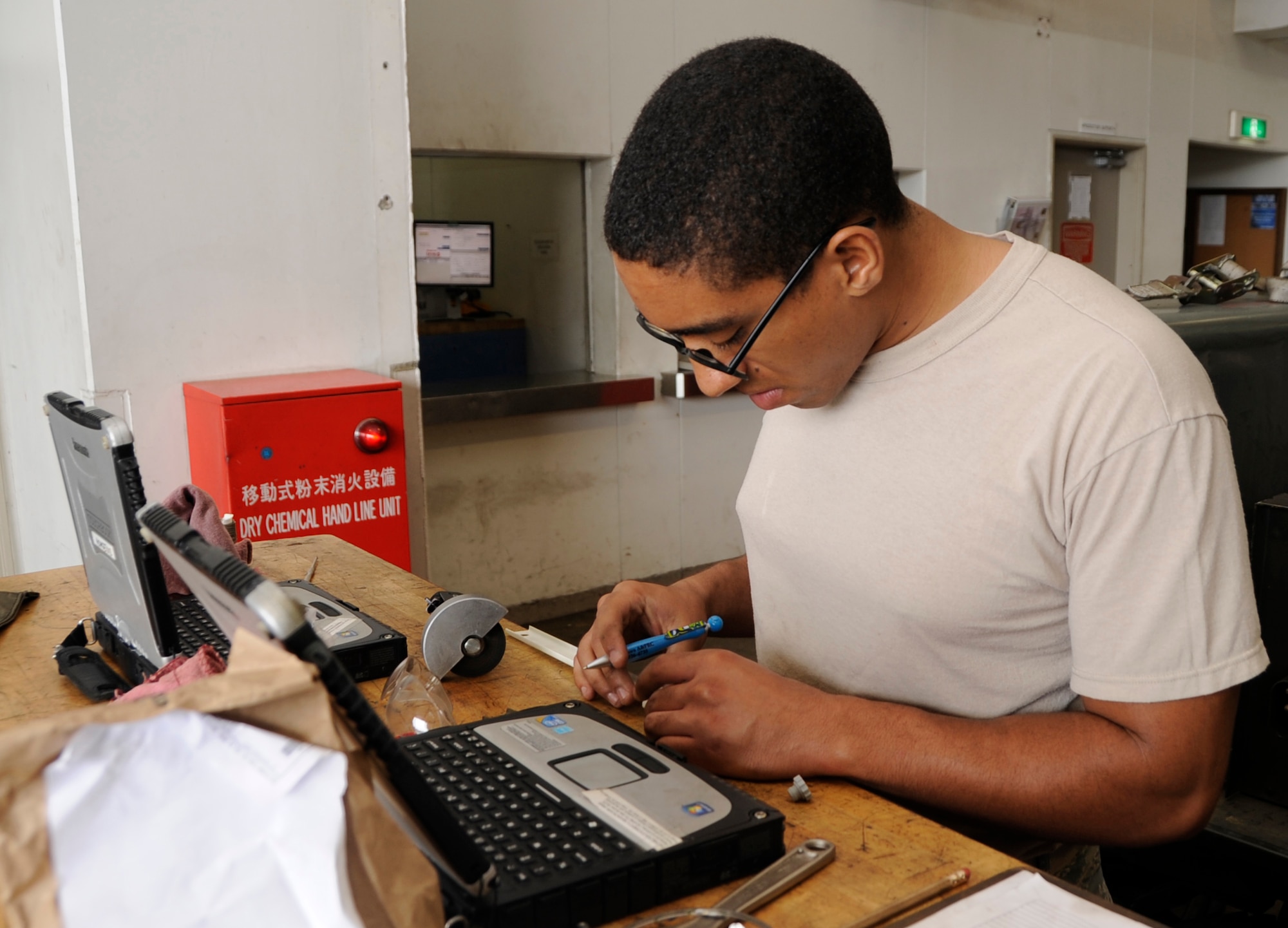 Airman 1st Class Davood Amini, 35th Maintenance Squadron Aerospace Ground Equipment apprentice, builds a terminal board guard as part of a phase-two periodic inspection at Misawa Air Base, Japan, Aug. 8, 2013. AGE members service, inspect and repair motor- and engine-driven generator sets, air conditioners, hydraulic test stands, bomb lifts and more. (U.S. Air Force photo by Airman 1st Class Kaleb Snay)
