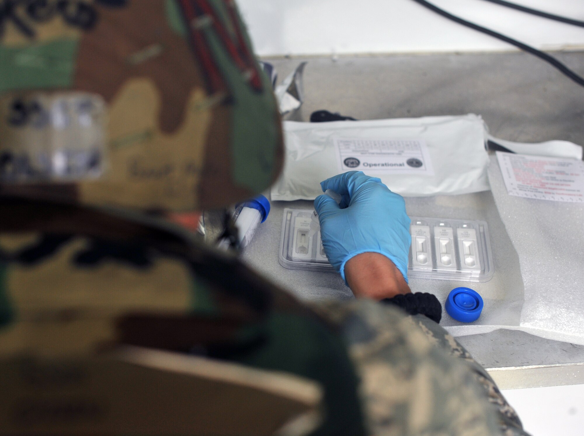 Staff Sgt. Mark Olsen, 51st Aerospace Medicine Squadron bioenvironmental engineering technician, drops liquid into a sample well on a hand held assay during Operational Readiness Exercise Beverly Midnight 13-03 at Osan Air Base, Republic of Korea, Aug. 9, 2013. The liquid is used for presumptive identification of potential biological warefare agents. After retrieving data, that intel is used to prescribe medical treatment to affected patients before they become symptomatic. (U.S. Air Force photo/Senior Airman Kristina Overton)