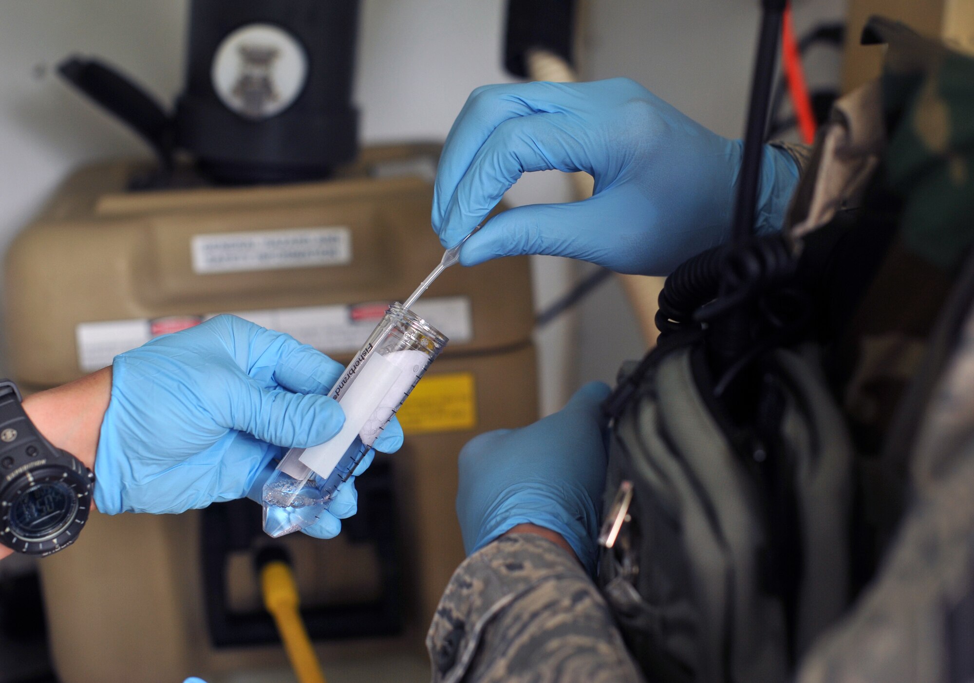 Buffer solution is extracted from a conical tube to retrieve any particles that are in the filter paper of a dry filter unit during Operational Readiness Exercise Beverly Midnight 13-03 at Osan Air Base, Republic of Korea, Aug. 9, 2013.  DFUs are checked every 12 hours, depending on the mission, where emergency management and bioenvironmental Airmen collect and change the filter.  (U.S. Air Force photo/Senior Airman Kristina Overton)